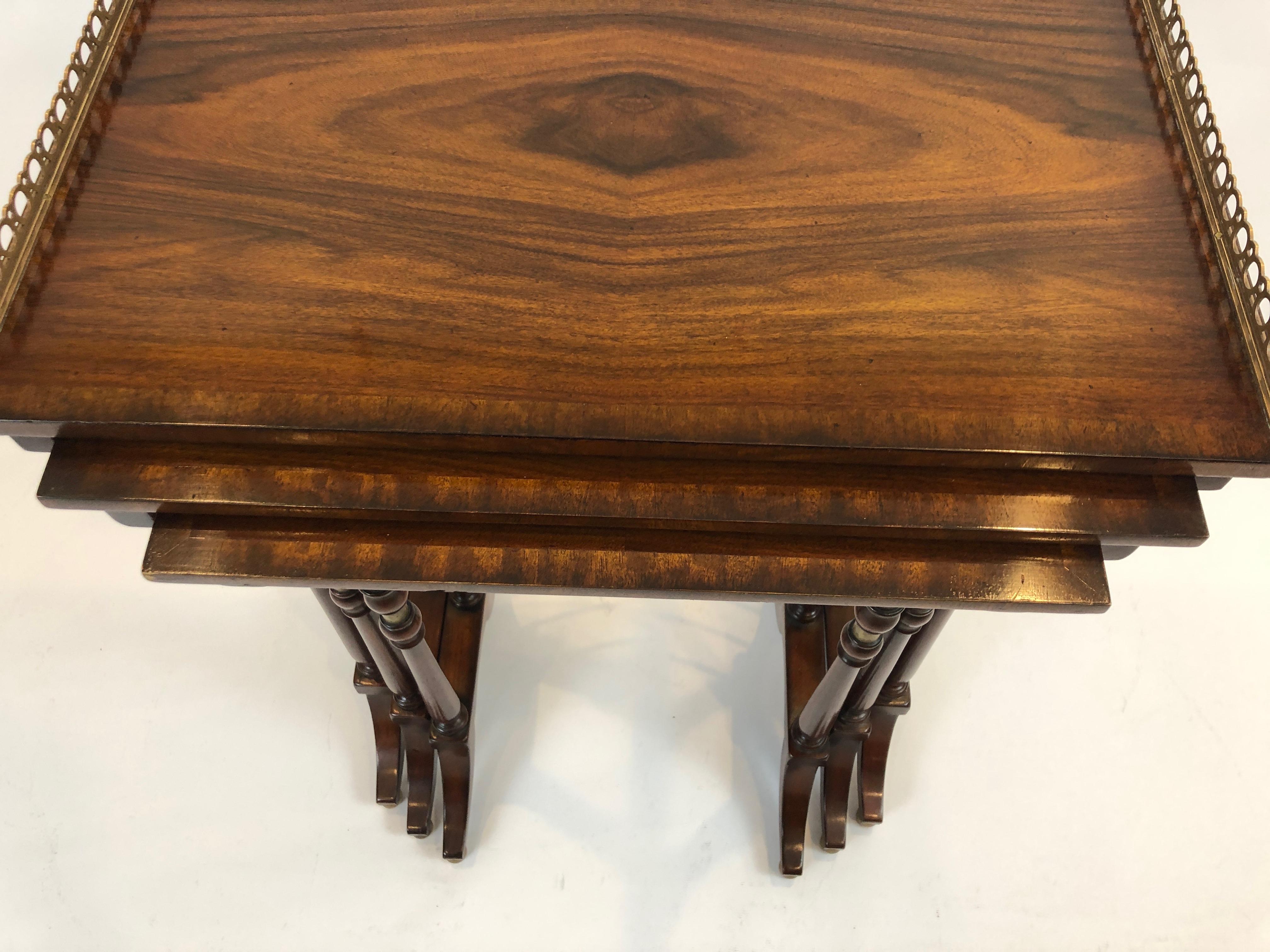A beautifully designed set of 3 nesting tables of magnificently grained zebra wood having brass gallery on the largest table, inlay around the periphery of all the tables and delicate ornately turned legs with brass stretchers.
Measures: Small
