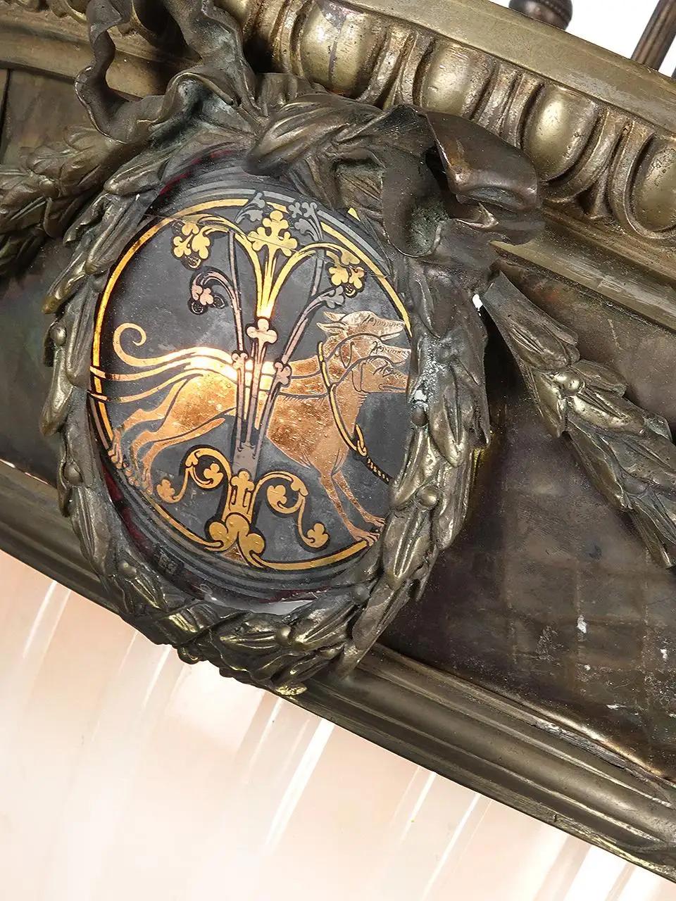 The lamp is early 20th century European. The Unicorn painted glass medallions are British Monarchy and read Mon Droit... My Right. One of the 4 pieces of glass is different and must have been replaced at some time. It shows 2 dogs. The main bronze