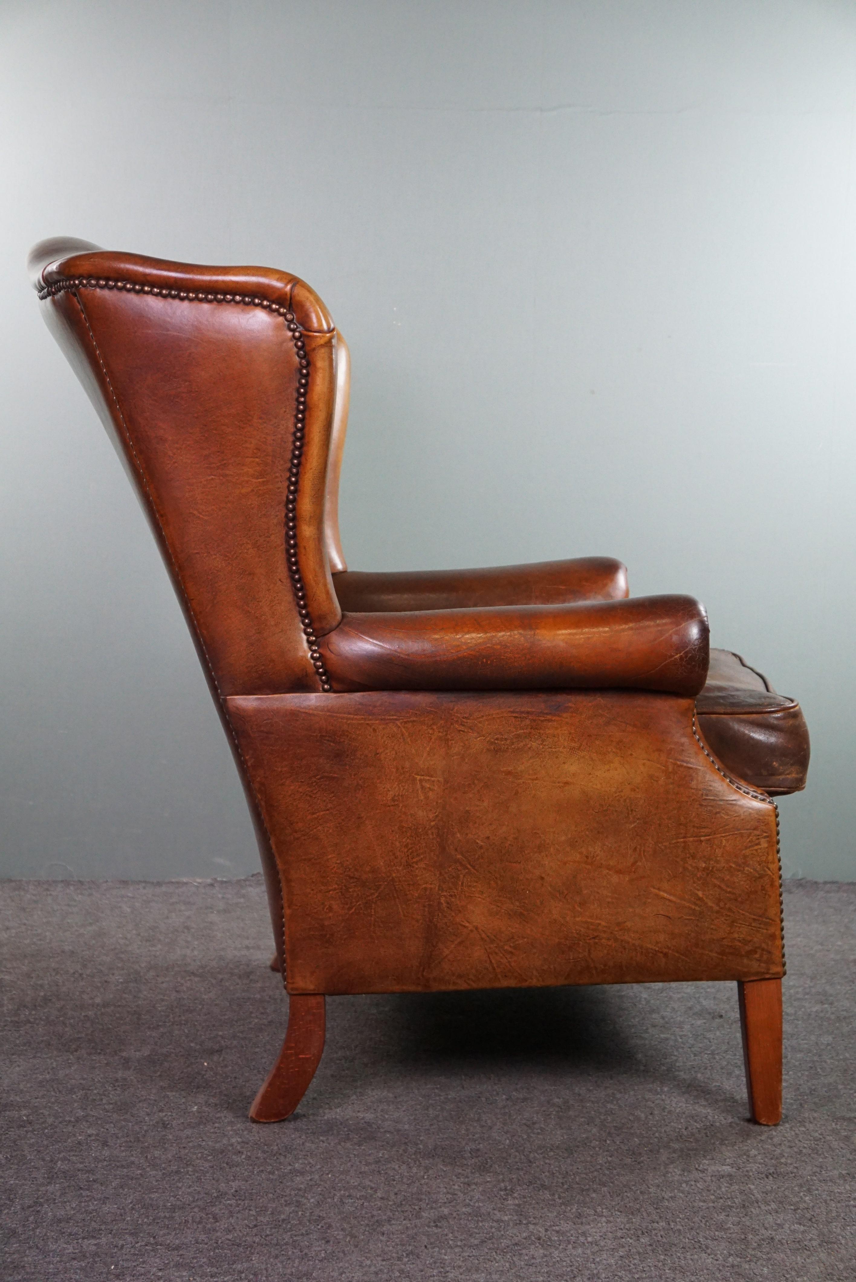 Very rugged wingback armchair made of cognac-colored sheep leather In Fair Condition For Sale In Harderwijk, NL
