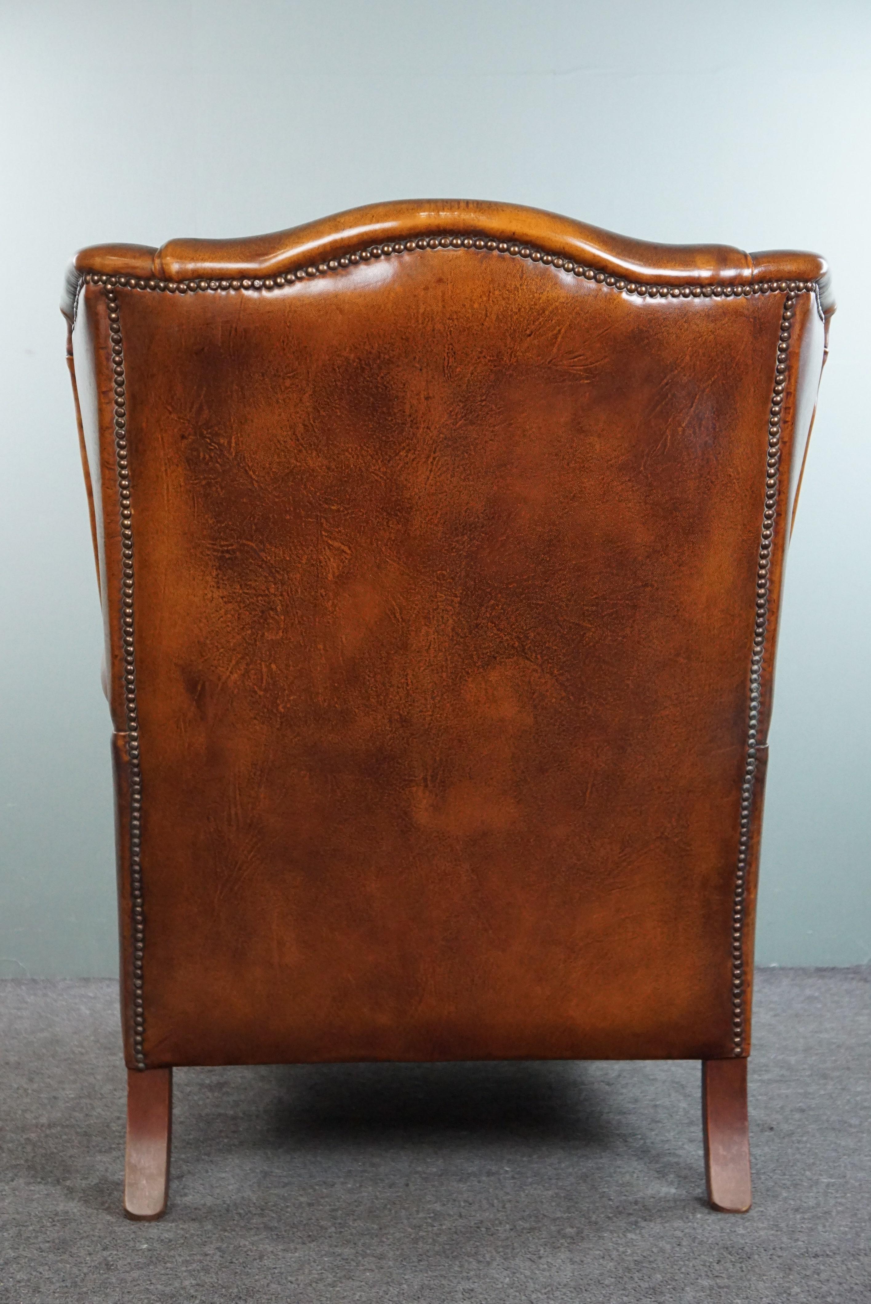 Late 20th Century Very rugged wingback armchair made of cognac-colored sheep leather For Sale
