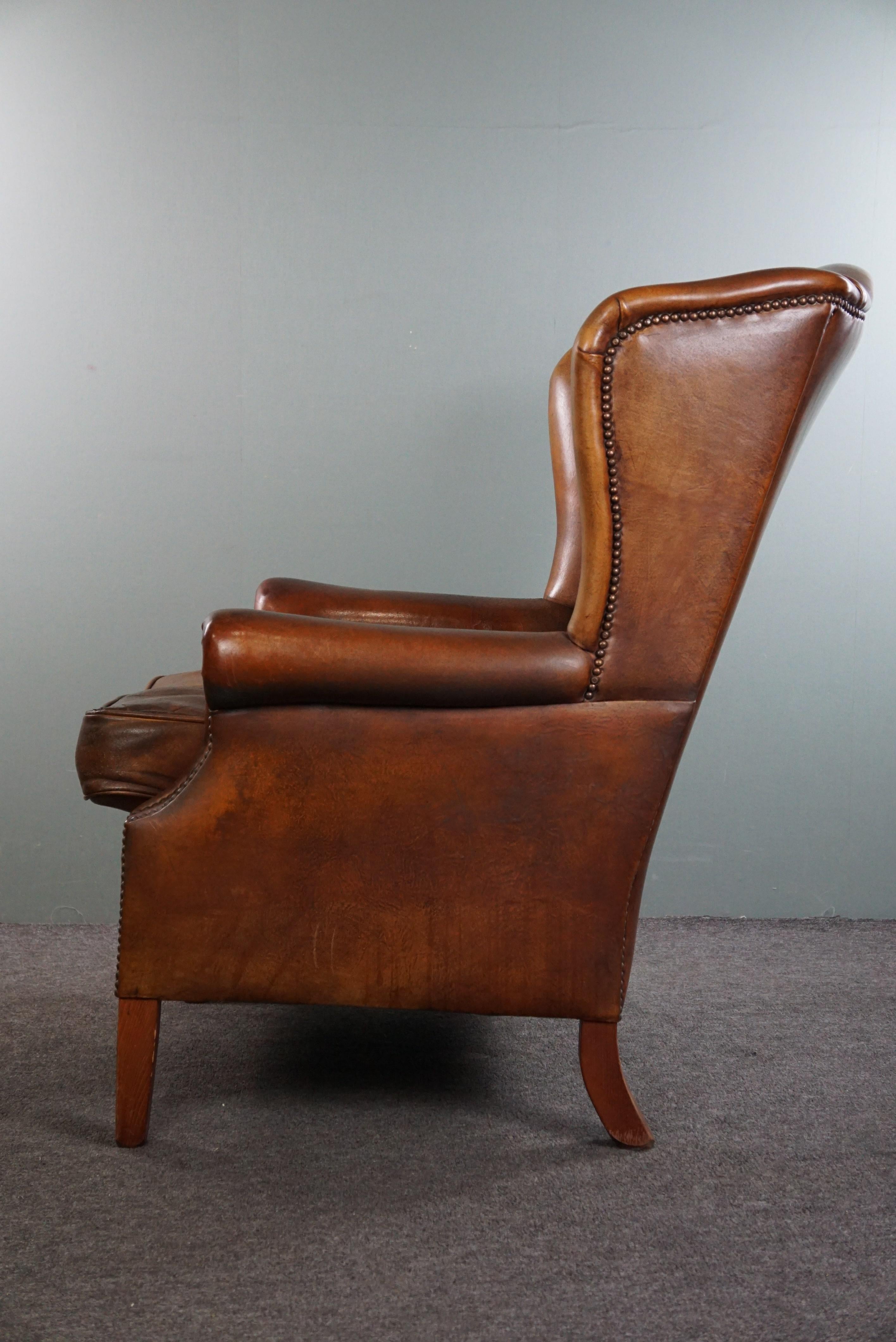 Leather Very rugged wingback armchair made of cognac-colored sheep leather For Sale