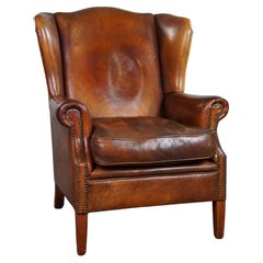 Fauteuil à oreilles très robuste en cuir de mouton de couleur cognac