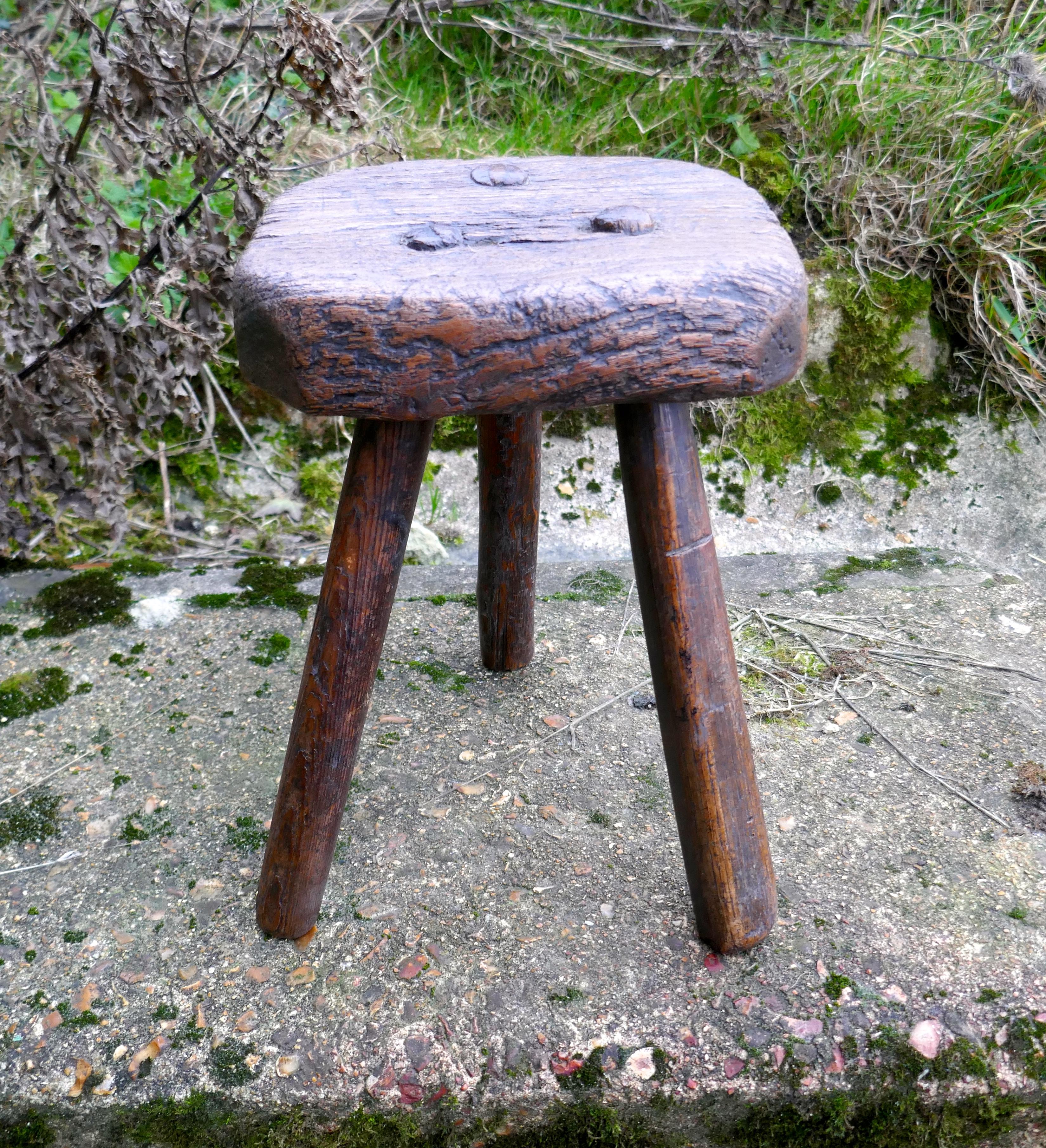 Very Rustic 18th Century Elm Dairy Stool or Milk Maid’s Stool

This is a very small piece, the stool is made in elm, the seat is made from one solid piece with the legs set into the slab, an easy piece for the Milk Made to carry 
The Stool is a