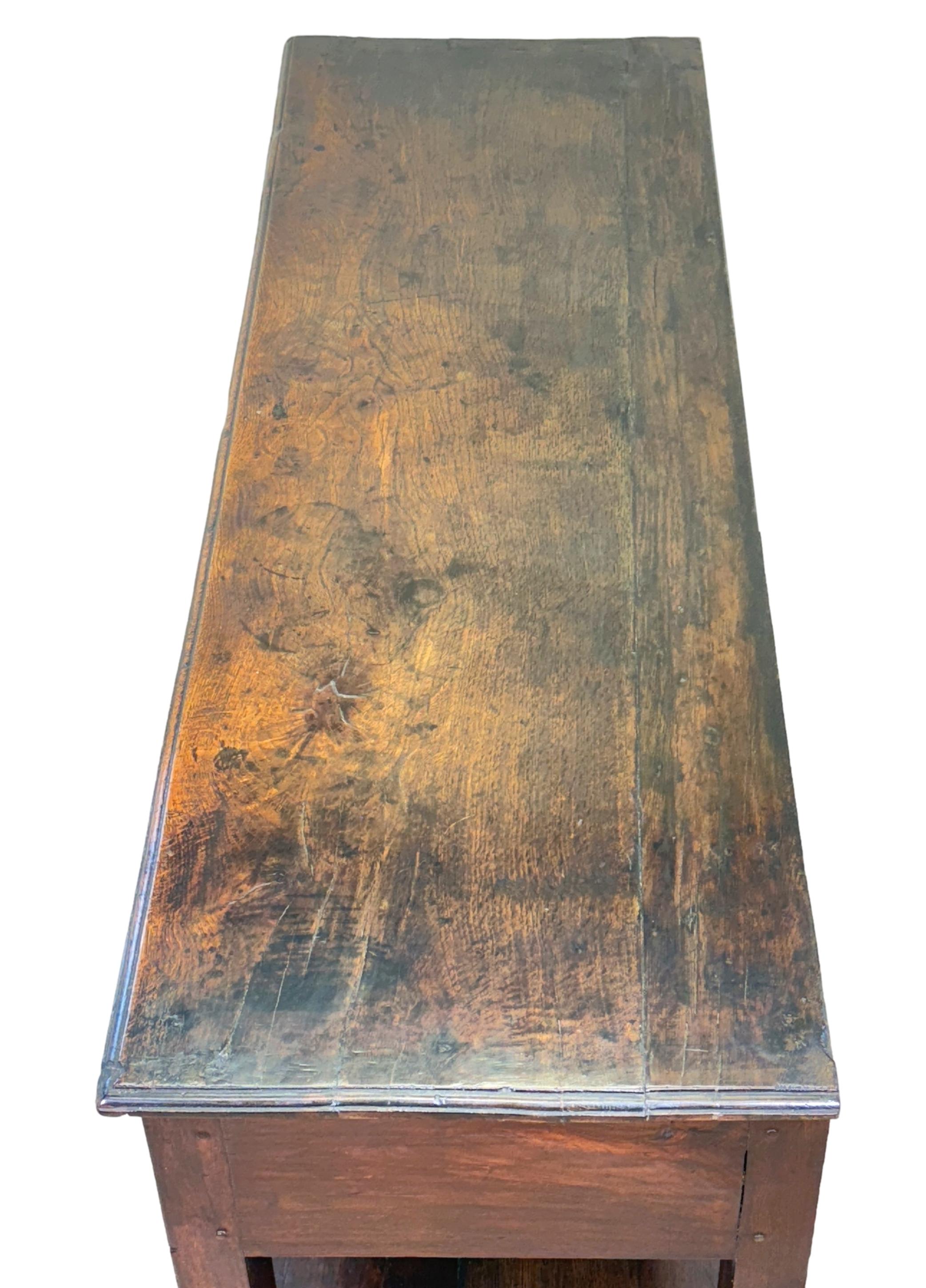 A Charming Mid 18th Century Oak Dresser Base, Or Georgian Sideboard, Of Rare Small Proportions, Retaining Rich Colour And Patina Throughout, Having Rectangular Plank Top Over Two Drawers With Replacement Old Brass Plate Handles And Elegant Shaped