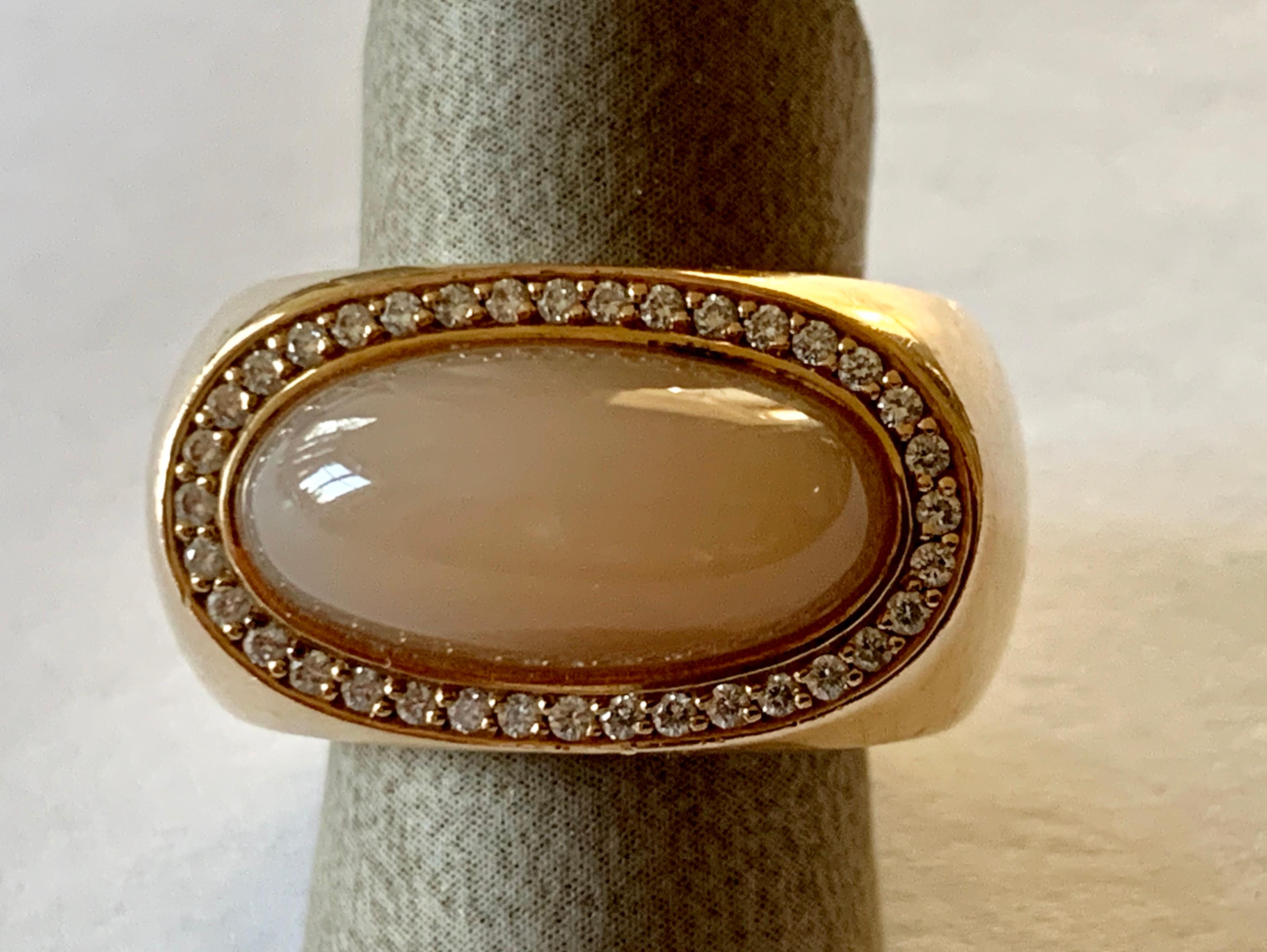 Moonstone and Diamond ring in solid rose Gold 750 created by the well-known German goldsmith Jochen Pohl. The beautiful brownish moonstone cabochon weighs 10.13 ct and is surrounded by 30 brilliant cut Diamonds totaling 0.30 ct, , F, vs. Jochen
