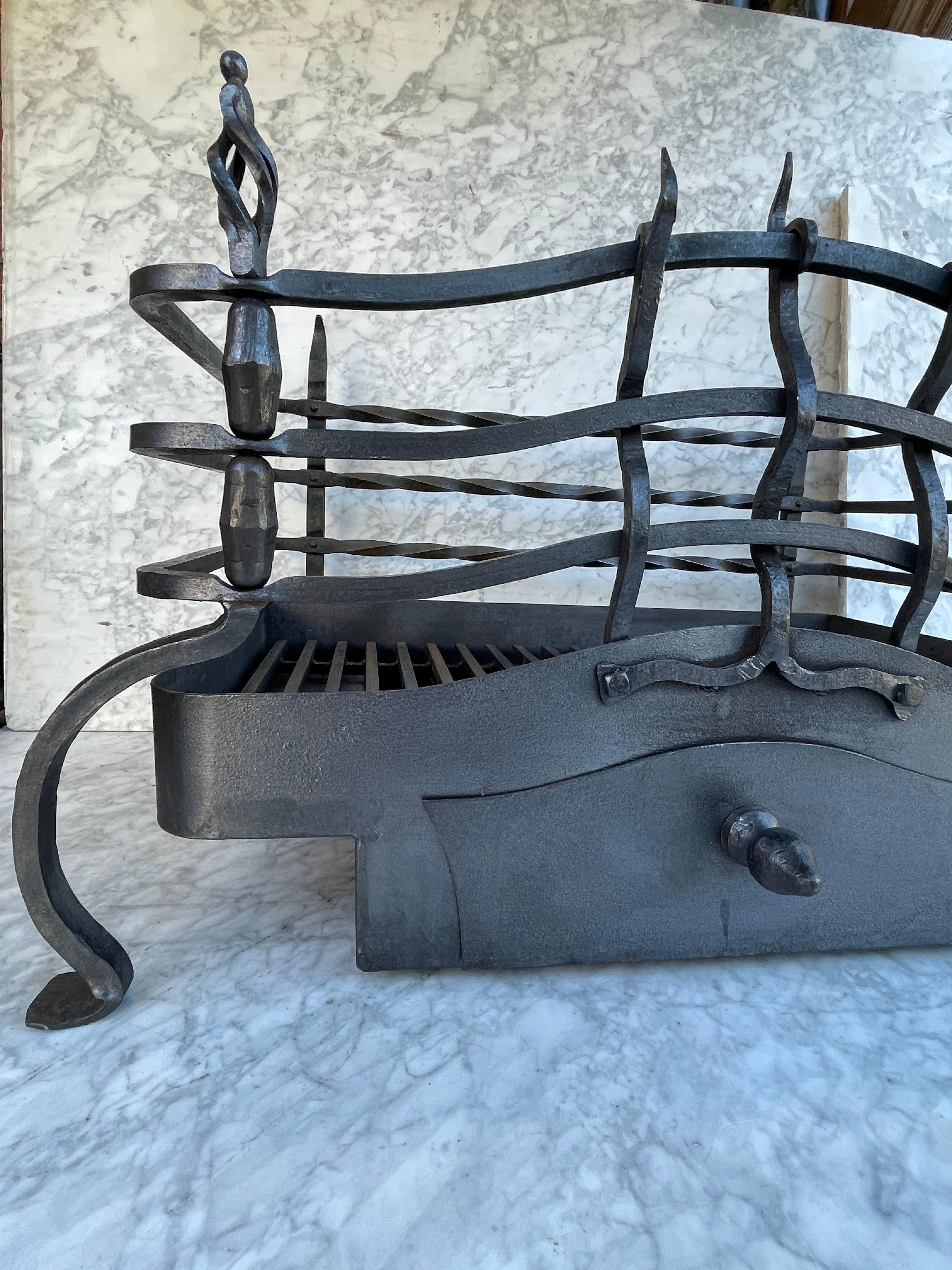 This wrought iron antique fireplace grate or basket is a real showpiece. The dimensions and craftsmanship are visible from every angle. The Basket comes with a removable ash drawer.