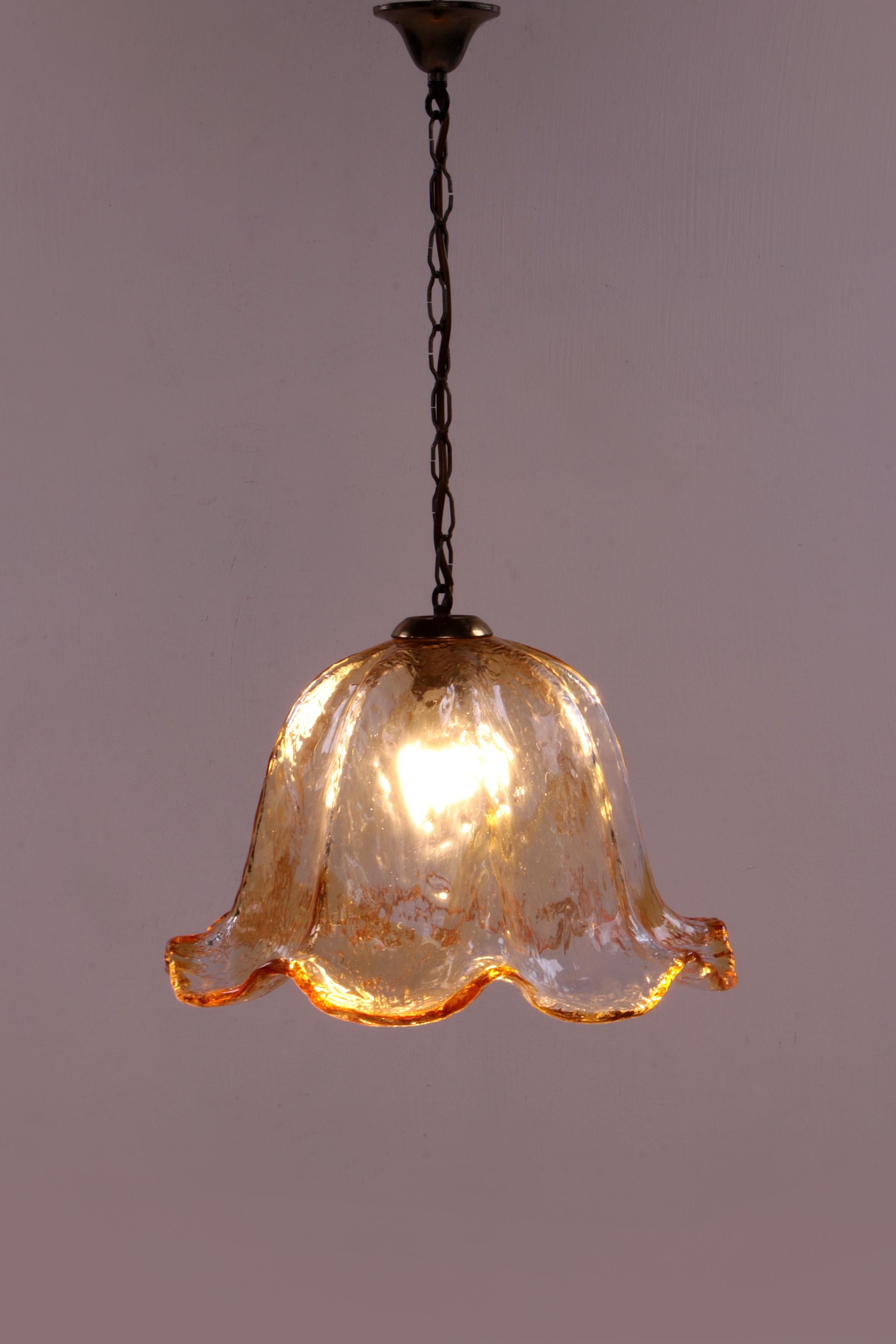 Very special Murano glass hanging lamp, 1960

The blown Murano glass has a beautiful orange and gold color on the edges.
As a result, this hanging lamp gives nice warm light. Considering its age, this hanging lamp is still in original and very good