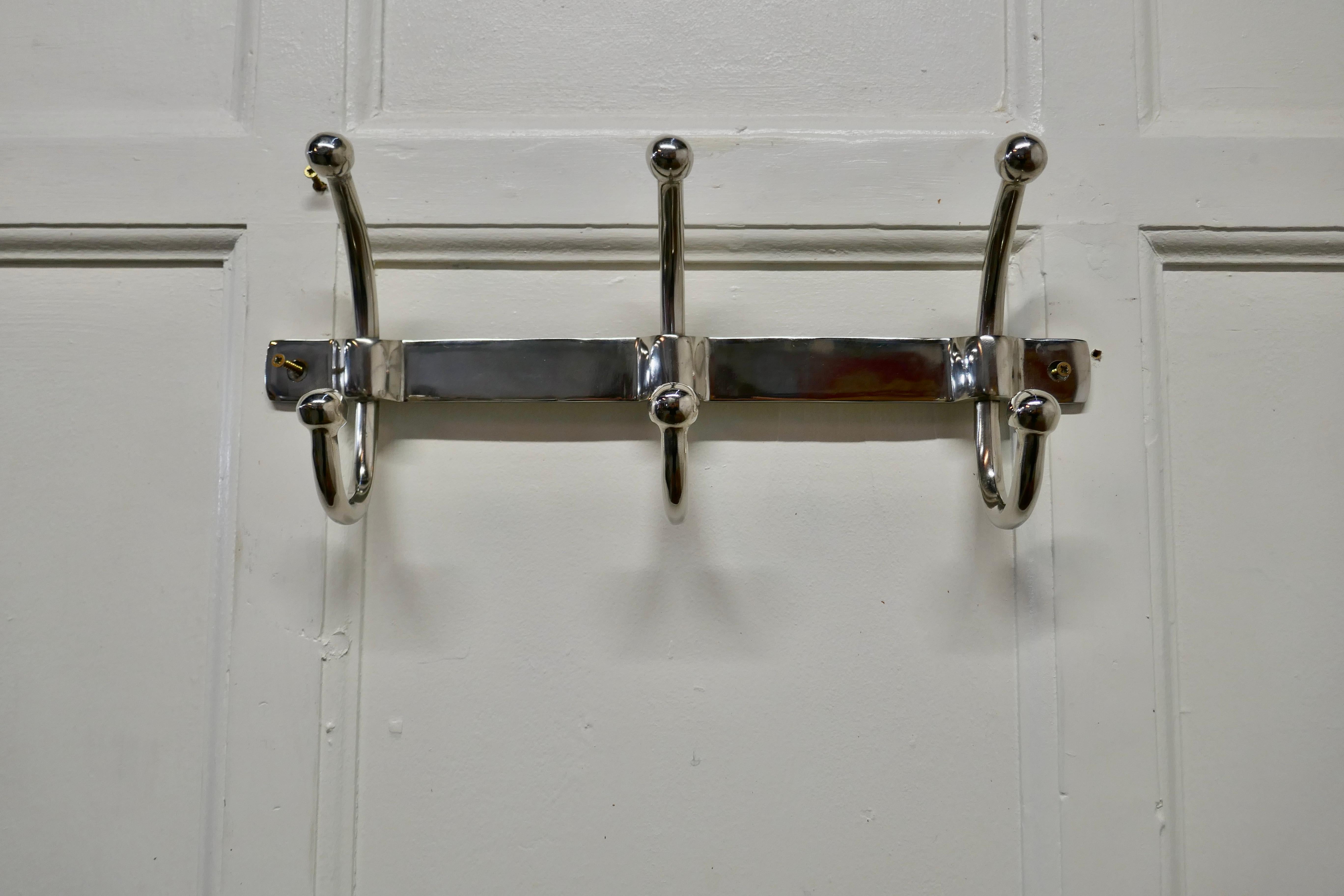 Very stylish chrome cloakroom coat rack

The rack has 3 double swan neck hooks
The bracket is 9” tall, 17” long and stands out 4” from the wall 
NV326.