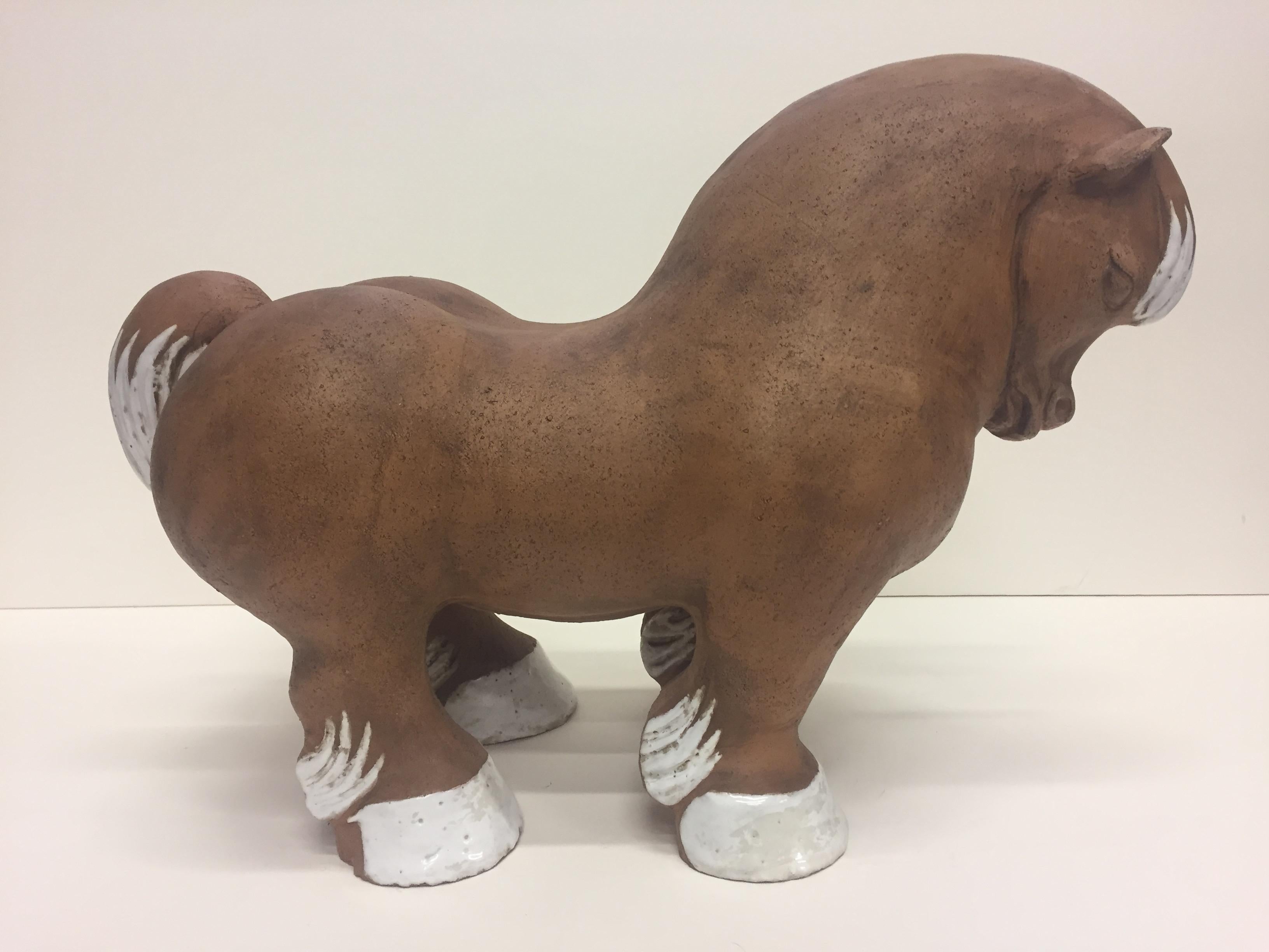 An eye-catching sensual terracotta sculpture of a horse in the style of Botero, with exaggerated curves and haunches, accented with white glazed mane and hooves.