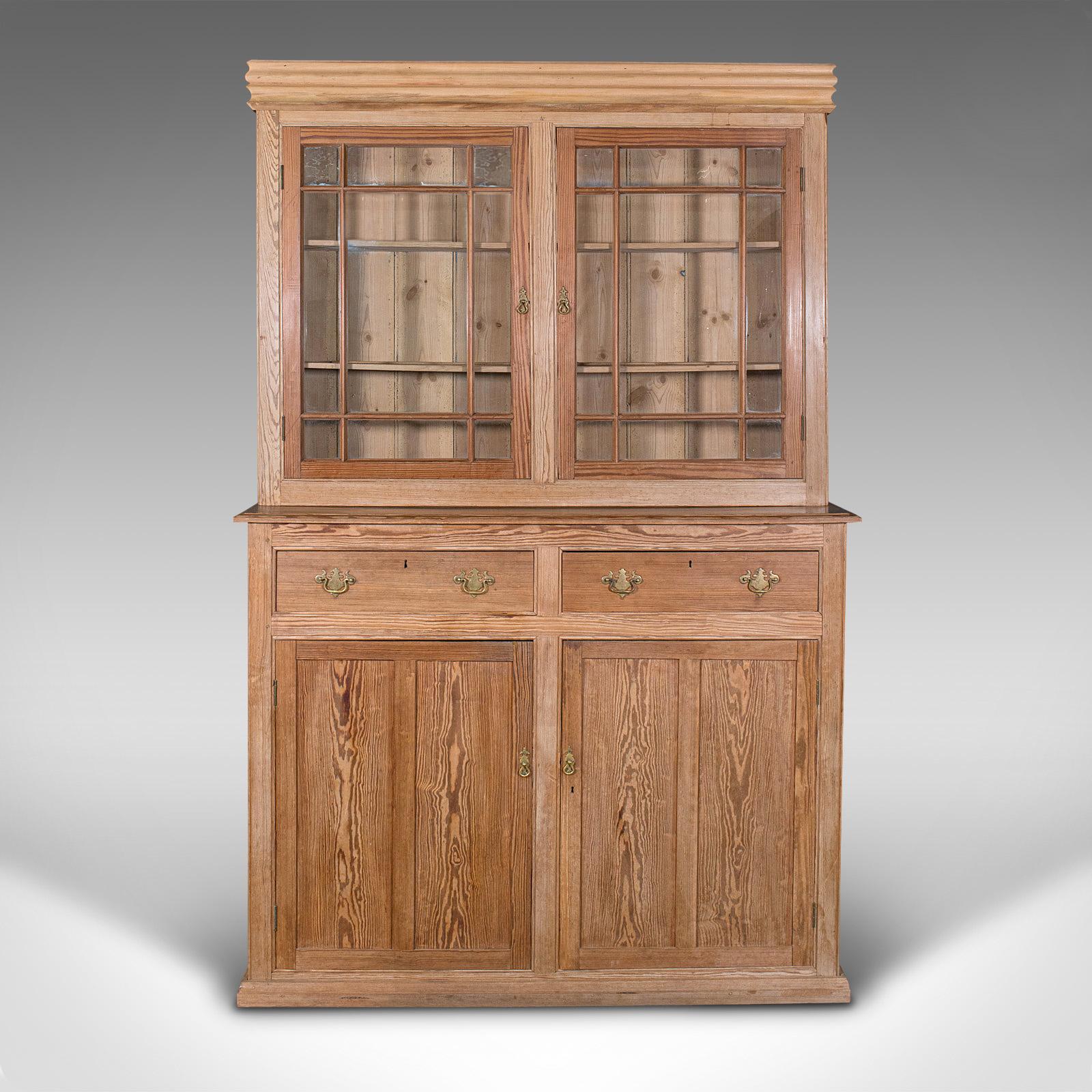 This is a very tall antique glazed cupboard. An English, pine sideboard dresser or larder cabinet, dating to the early Victorian period, circa 1850.

Of townhouse or country estate proportion at 8' 03