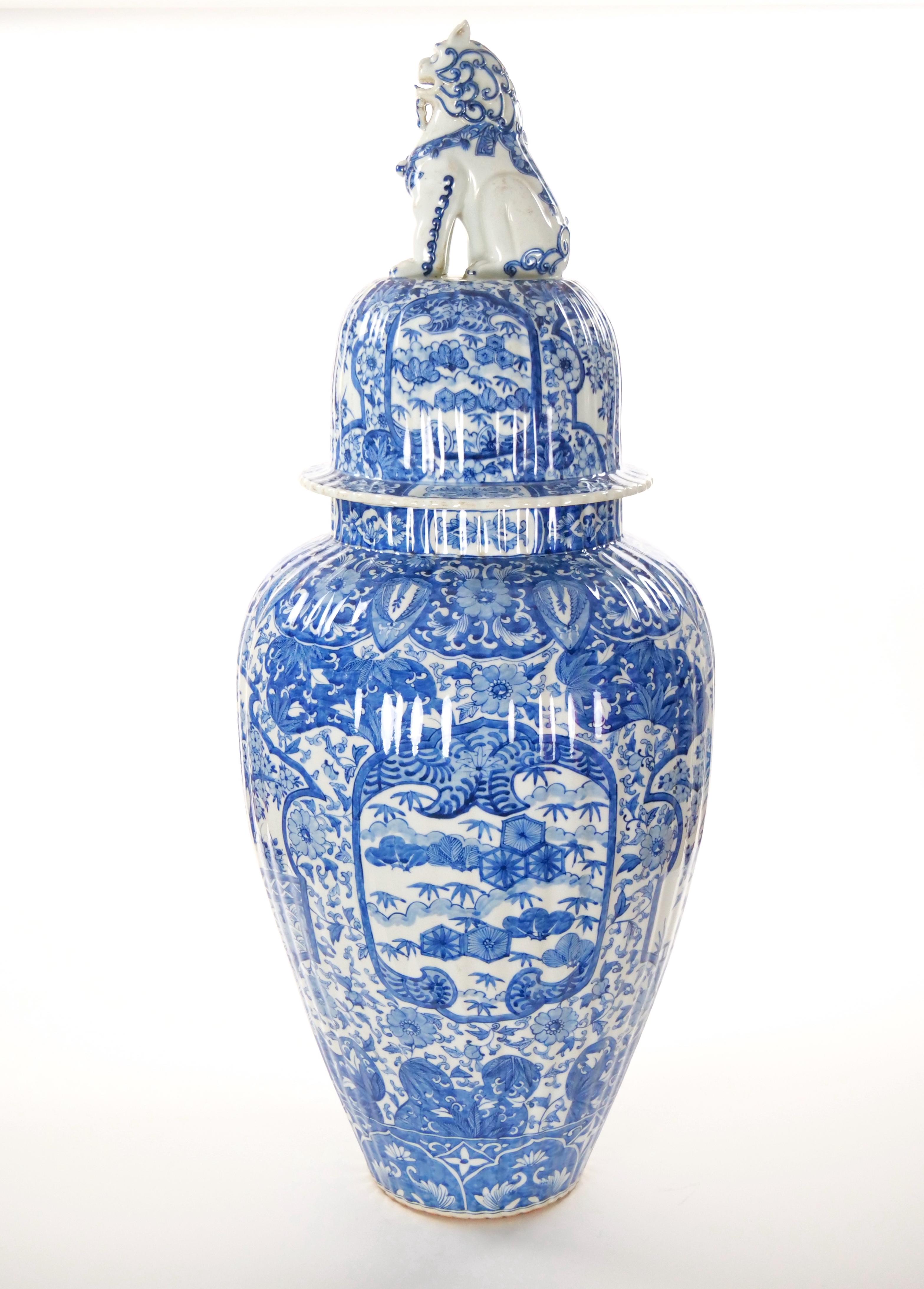 This exquisite late 19th-century glazed porcelain ginger jar urn showcases an intricate Chinoiserie design in classic blue and white. The exterior features elegant decorative motifs and swirl details, epitomizing the artistry of the period. Topping