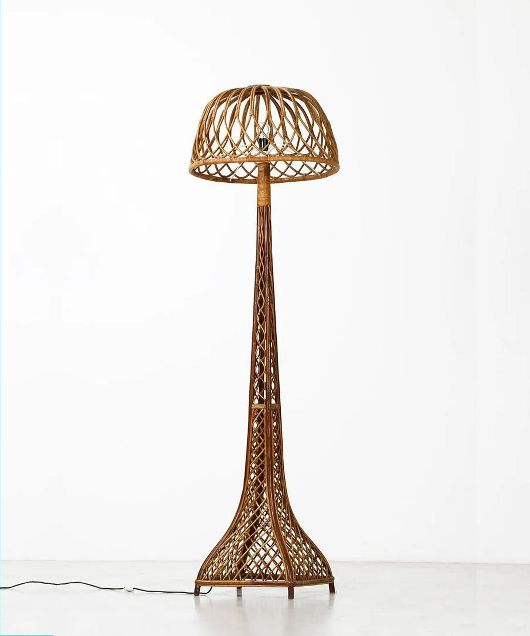 Very tall and stylish Italian rattan floor lamp. This rattan is skillfully crafted and woven with a dynamic criss cross pattern. The fluid lines give this lamp great visual interest and an open, welcoming character. The base's substantial footprint