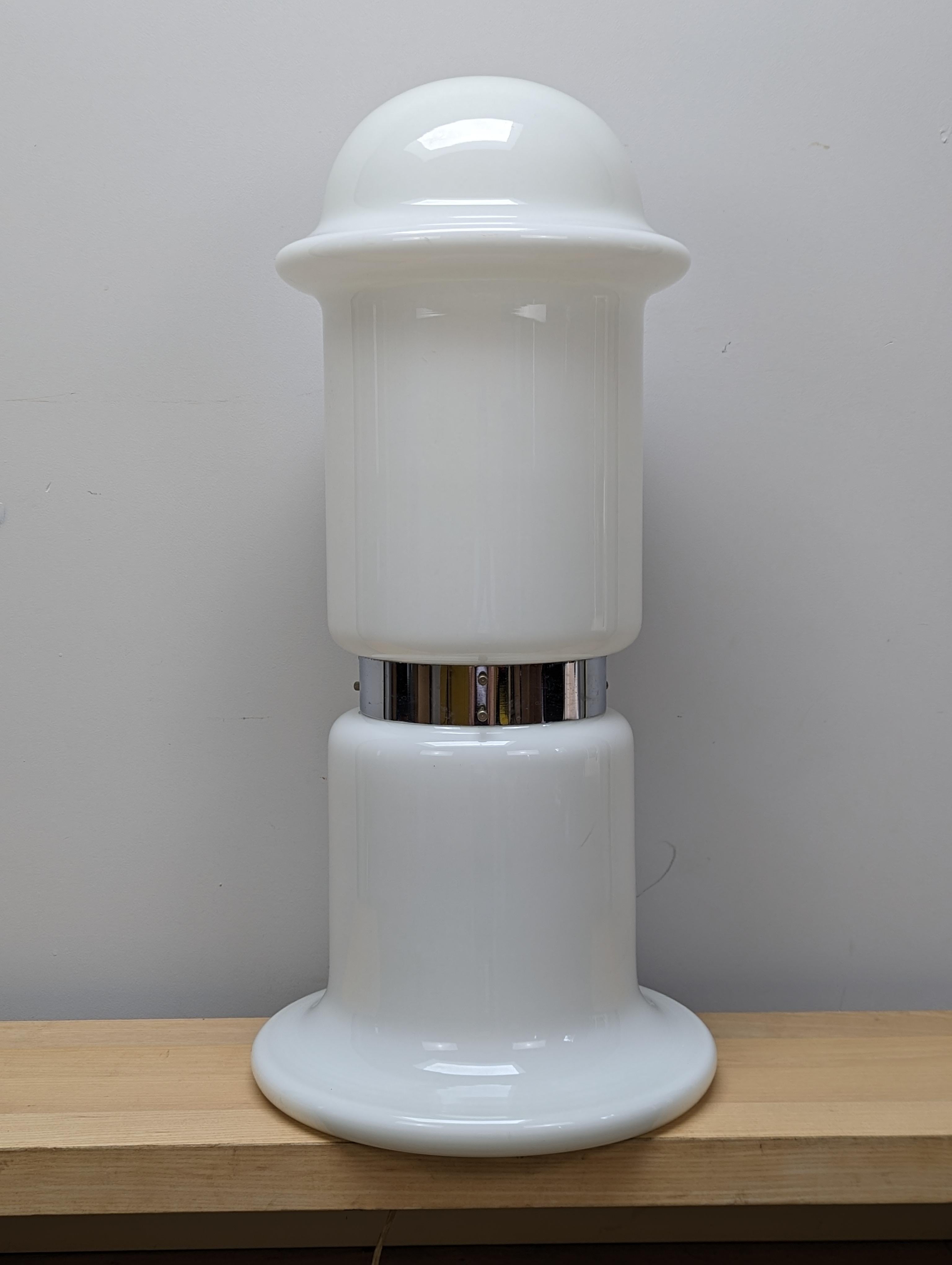 The lamp was designed by Karel Volf. The lamp is made of milky triplex opal glass and consists of two parts, the base and the top shade. They are divided in the middle by a metal ring. When lit, it produces a very pleasant dim light.

Glass floor