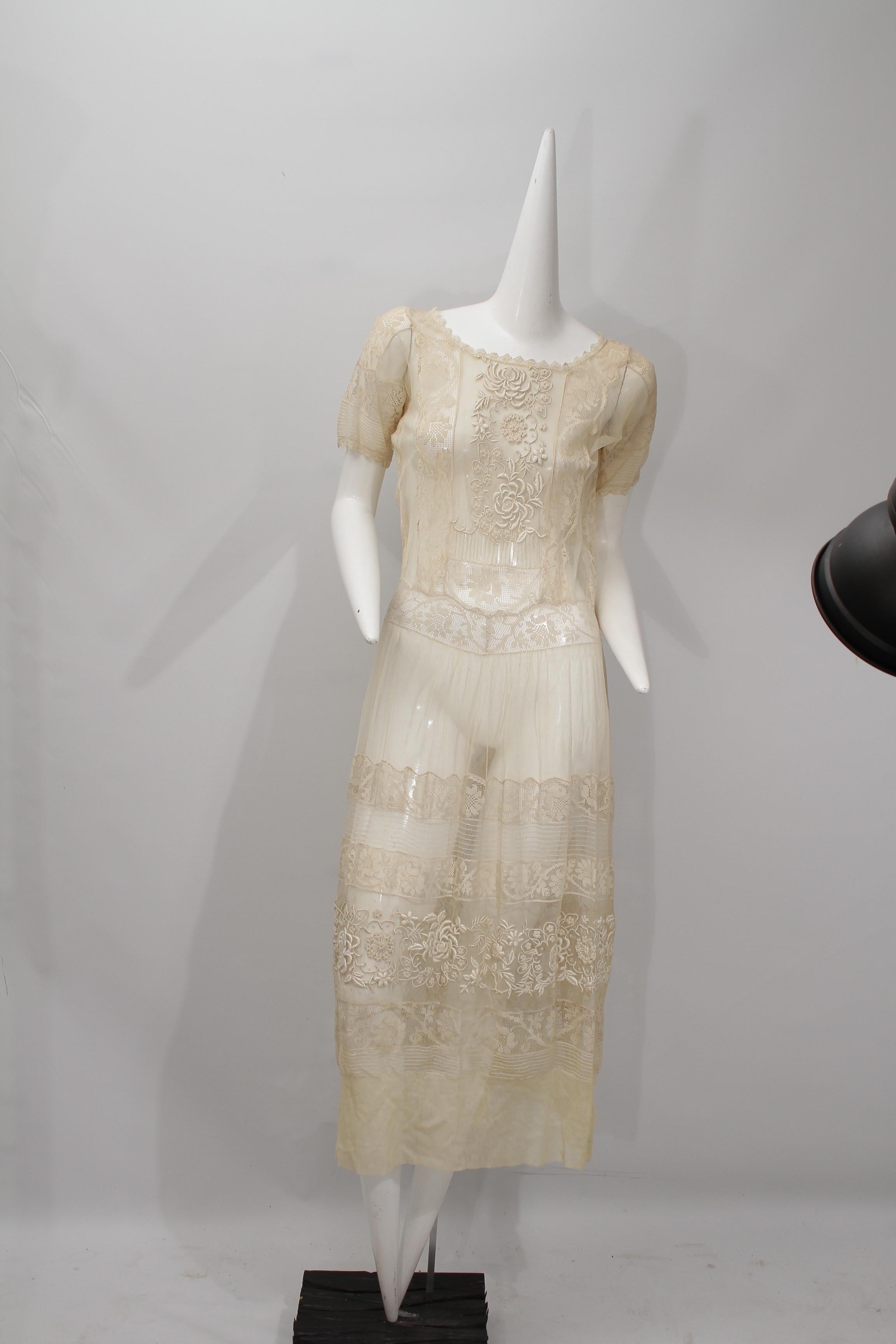 Very vintage lace and embroidered sheer ecru long dress with short sleeves. 

Great condition with no tears, no pulls and no holes. This dress would make a lovely wedding dress.

This is approximately a size US4