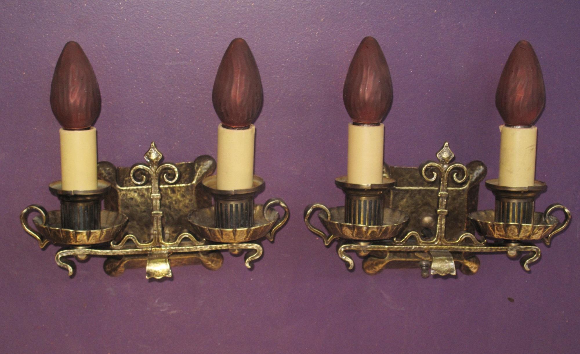 Wonderful sconces designed to fit into several of the decorating styles of their time, Tudor, Spanish Revival, Craftsman, Storybook, and/or Gothic. There is a lot going on with these sconces which one would not notice at first glance. The keen