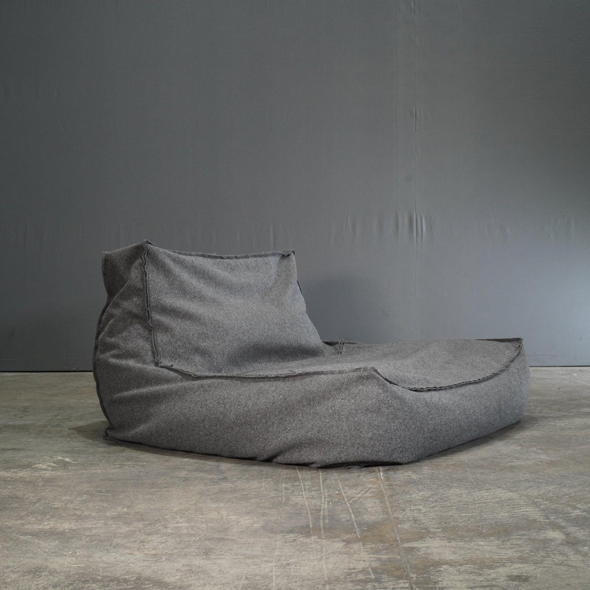 The Verzelloni Zoe Grey Armchair by Lievore Altherr Molina is a relaxed yet sophisticated seating solution, ideal for modern interiors. Featuring a low-slung, minimalist silhouette, this armchair is upholstered in soft grey fabric, offering both