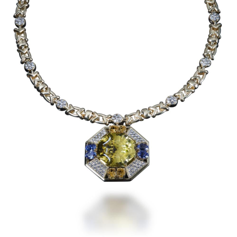 Rigorous geometric shapes for the Necklace “Gaia” featuring a 37,10 carats Citrine with Yellow and Blue Sapphires for 4,35 and 4,10 carats, enriched with Brilliant-cut Diamonds for 3,75 carats, G-H colour, IF-VS clarity, set in 18 kt Yellow Gold.