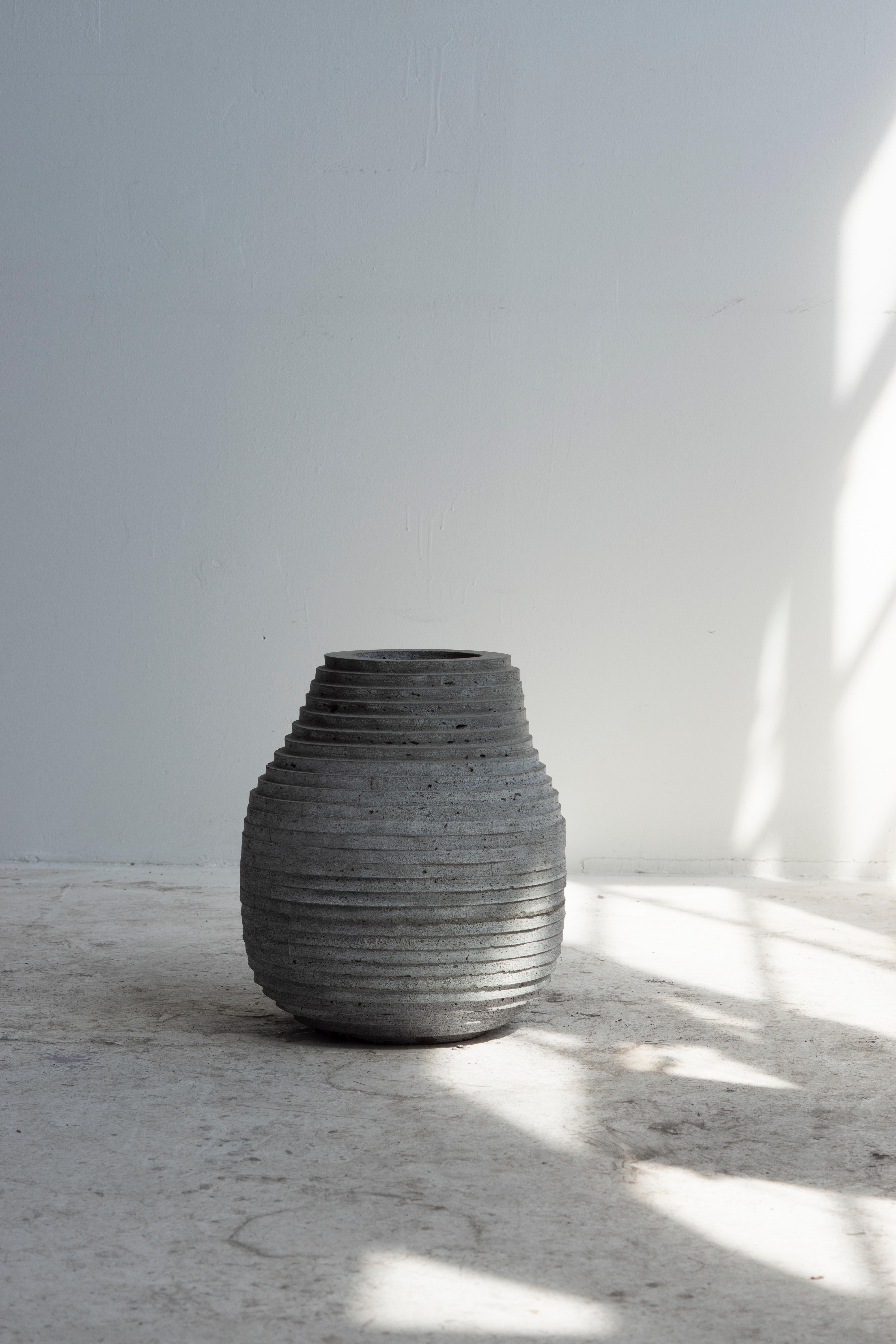 Hand-cast vessel for indoor and outdoor use. Drainage holes can be added.

At the intersection of art, craft, and design, Concrete Poetics' debut collection of hand-cast cement sculptural furniture and accessories streamlines visually intriguing and