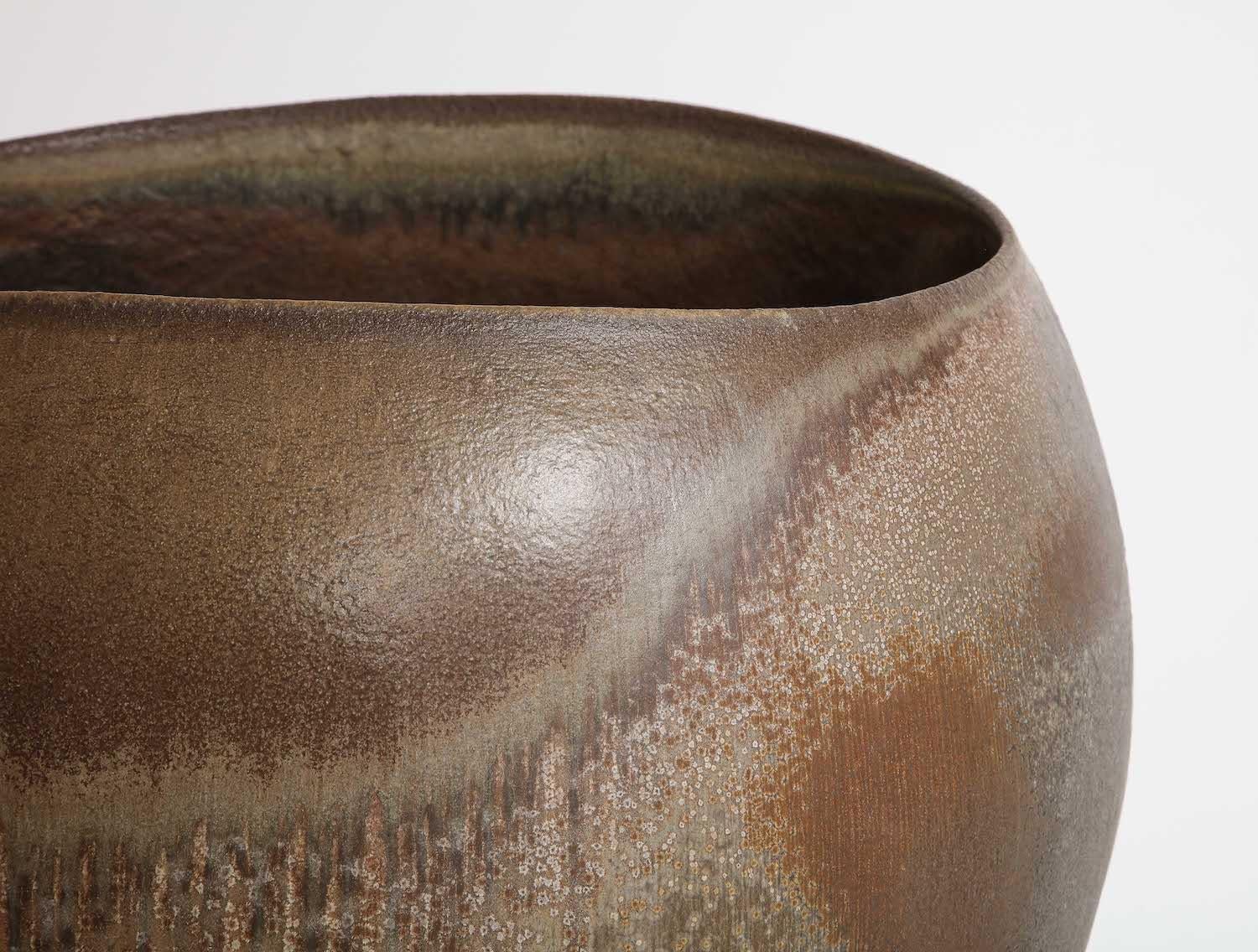 Large-scale footed bowl of irregular form. Glazed stoneware. Wood fired. Signed on underside.