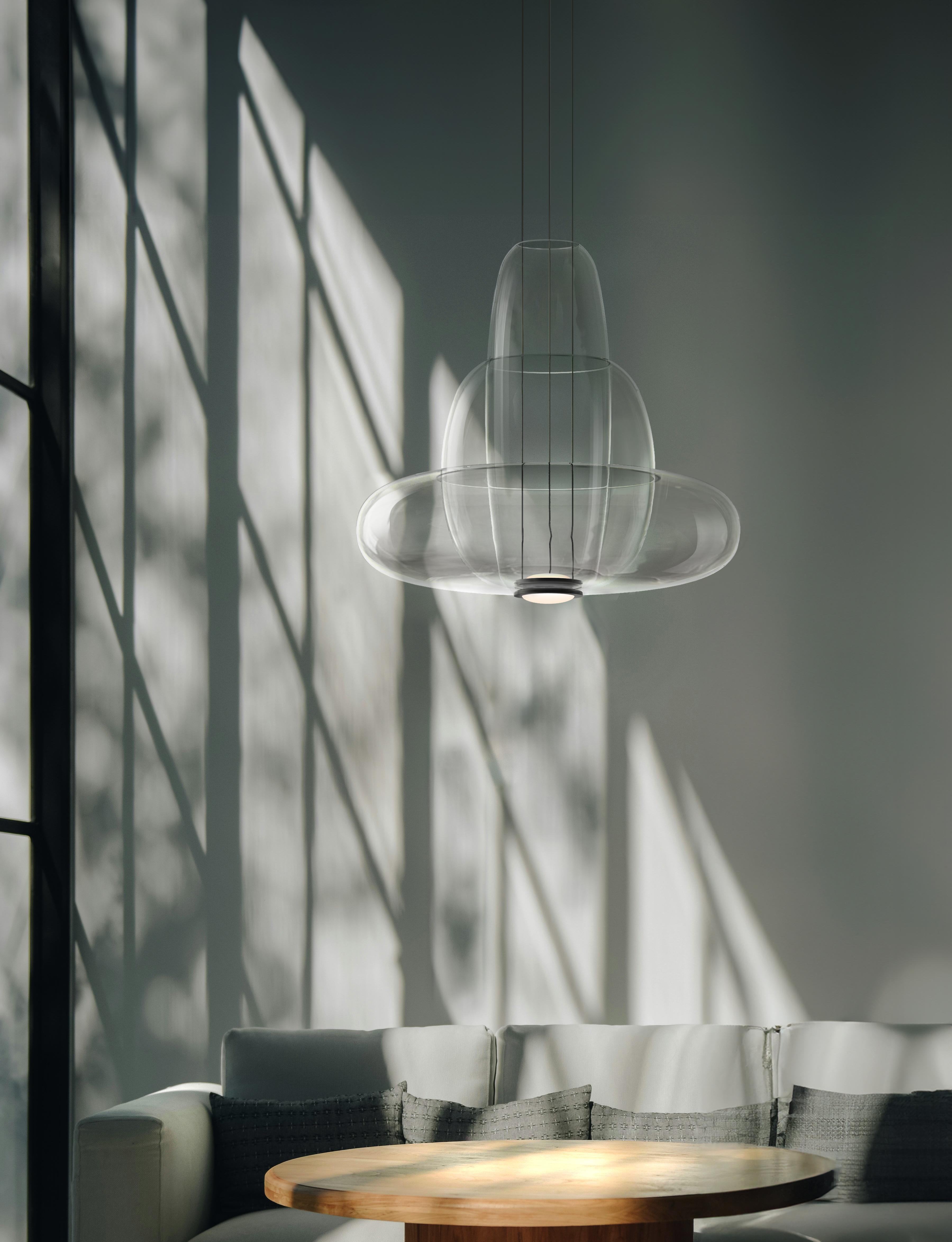 Vessel 3 Part Pendant Lamp by Shulab Studio
Dimensions: W 51 x D 51 x H 46 cm.
Materials: Transparent Glass.

Also available in Smoke grey glass and Smoke brown glass.

Studio shulab is an internationally acclaimed design studio founded by designers