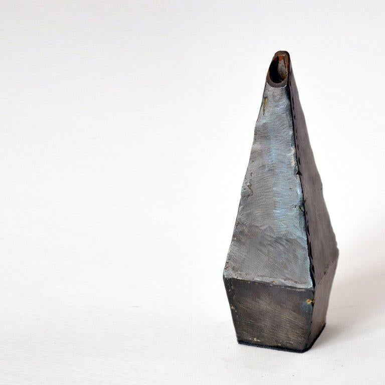 Eight facets form this unique object. Mathematically designed and hand-wrought.

Blackened steel, waxed finish, suede base.

Each vessel is unique and will vary slightly in size and shape from description.

Handmade in New York.
 

