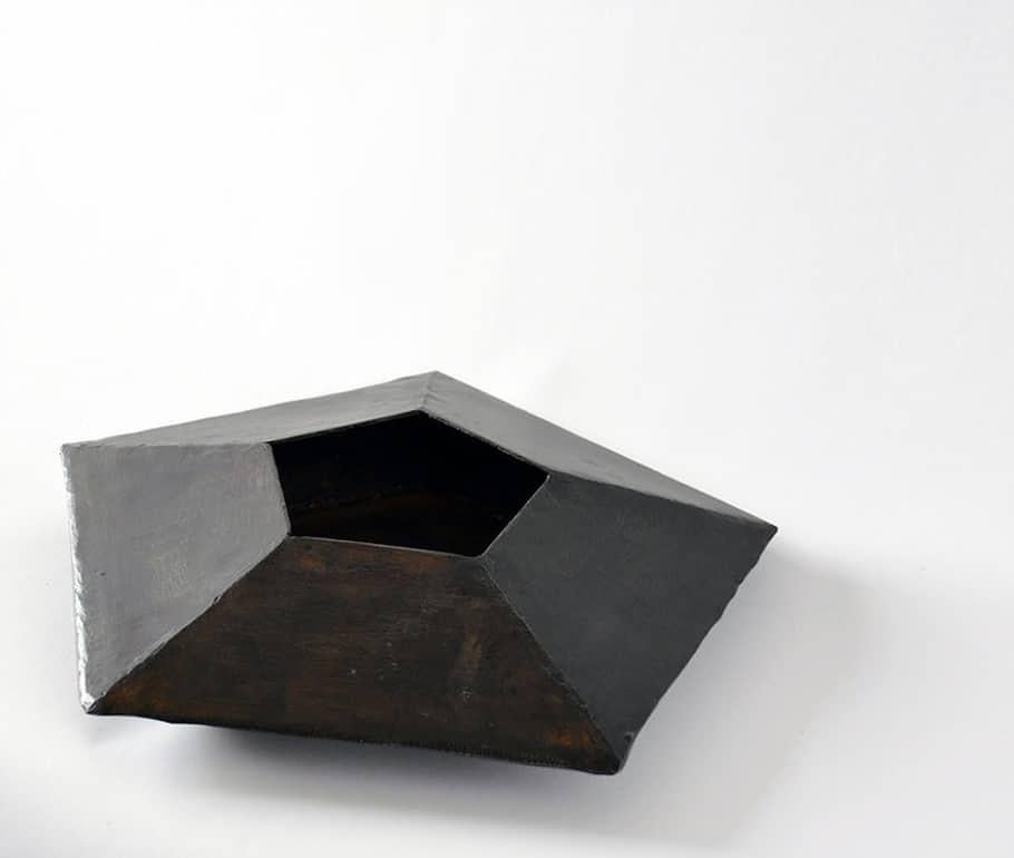 Ten facets form this unique object. Mathematically designed and hand-wrought.

Blackened steel, waxed finish, suede base.

Each vessel is unique and will vary slightly in size and shape from description.

Made in New York.


 