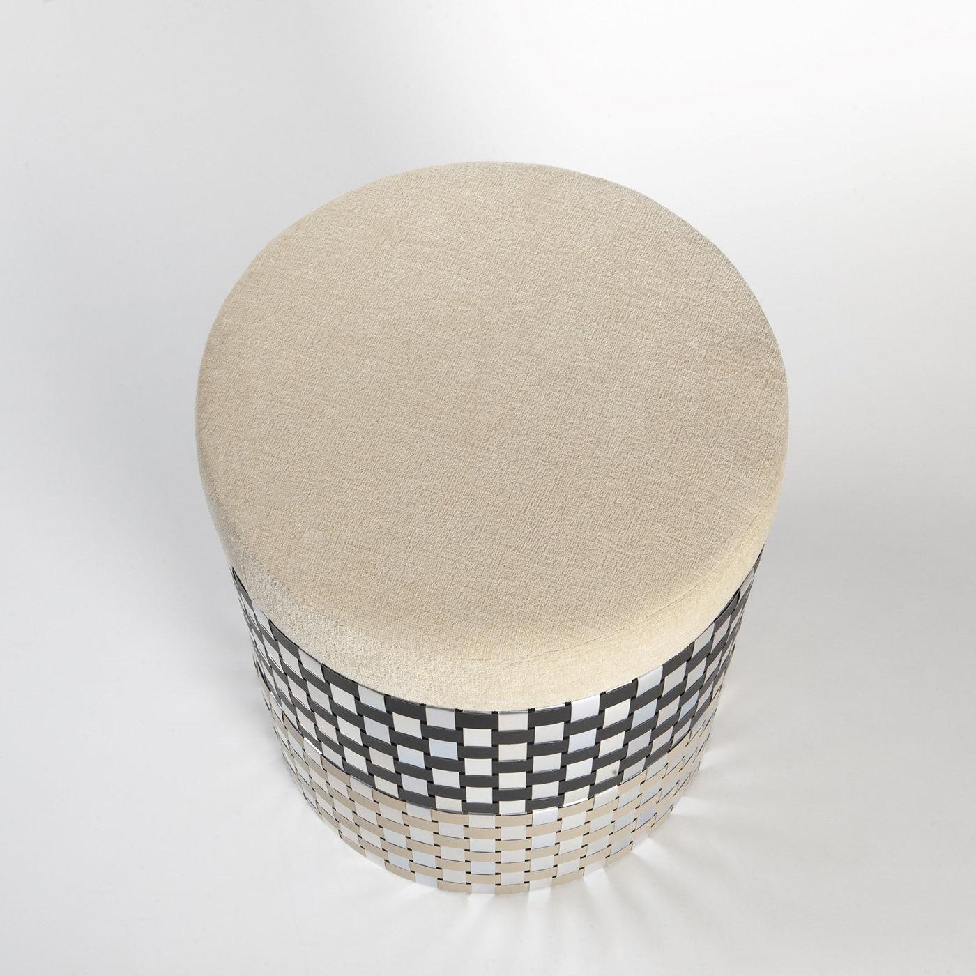 Simple in shape yet hypnotizing in design, this cylindrical pouf is named after Vesta, the virgin goddess of the hearth, home, and family in Ancient Rome. Topped by a plush, round seat cushion, its wheeled silhouette consists of recycled aluminum