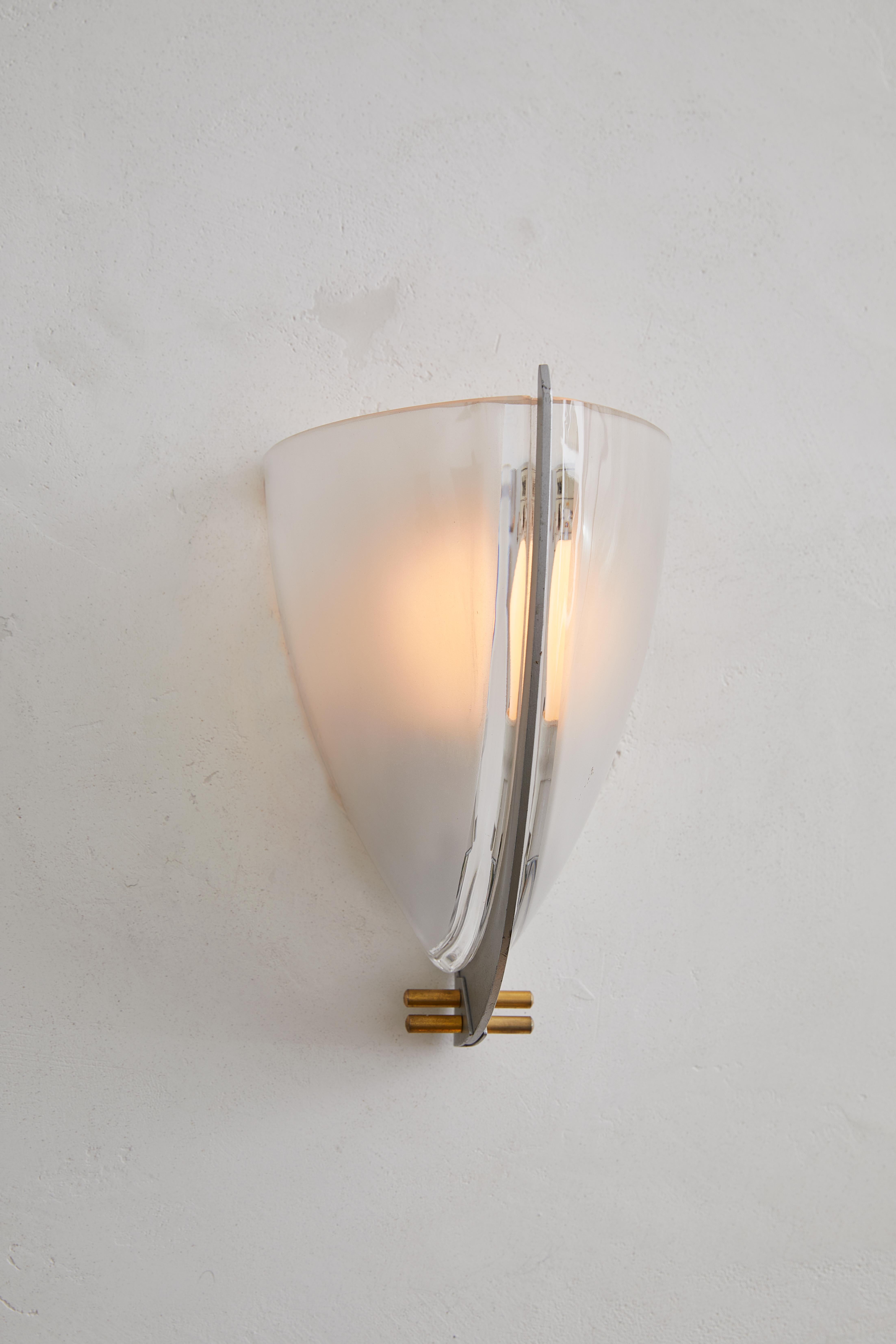 A rare pair of postmodern Italian wall sconces, the Vesta model was designed by Ernesto Gismondi for VeArt around 1990, capturing the bold experimentation of late 20th-century Italian lighting design. These striking fixtures combine mixed materials,