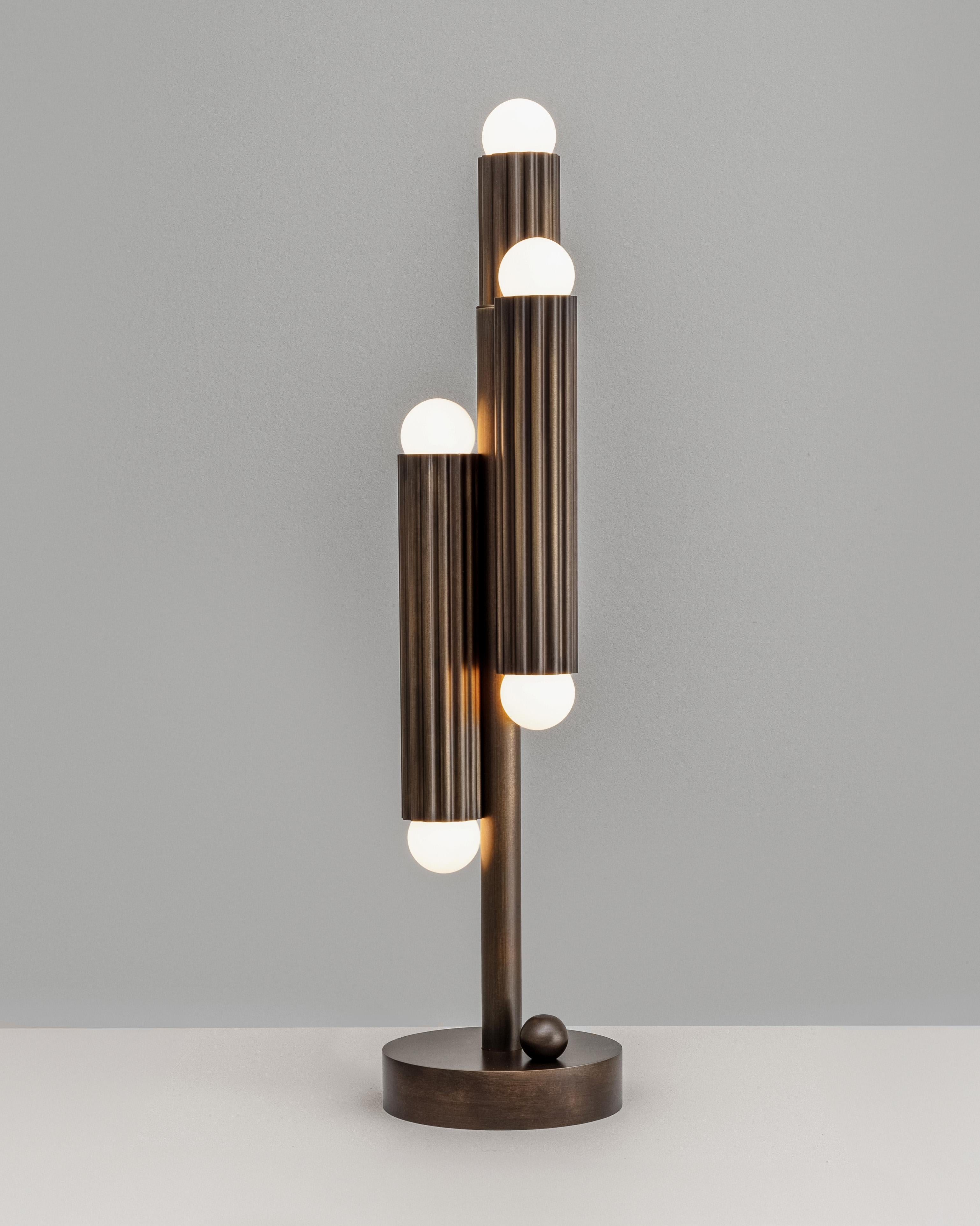 Thirty-two fluted solid brass cylinders are suspended in diamond formation, and a constellation hovering in space. From the side, vertical lines unfold in suspended harmony; from below, a celestial map of light emerges. Sculptural, commanding, and