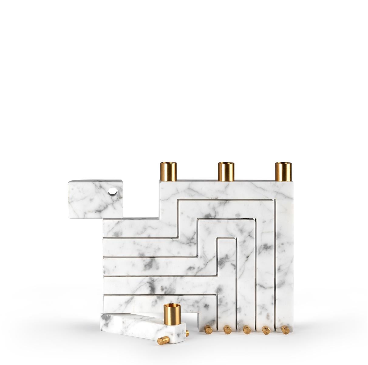 The Vestalia White Bianco Carrara Marble and Brass Details Candleholder is a unique and eye-catching sculptural piece.
When it is closed, the candelabrum appears like a monolithic marble slab. With just a few small touches, however, Vestalia opens