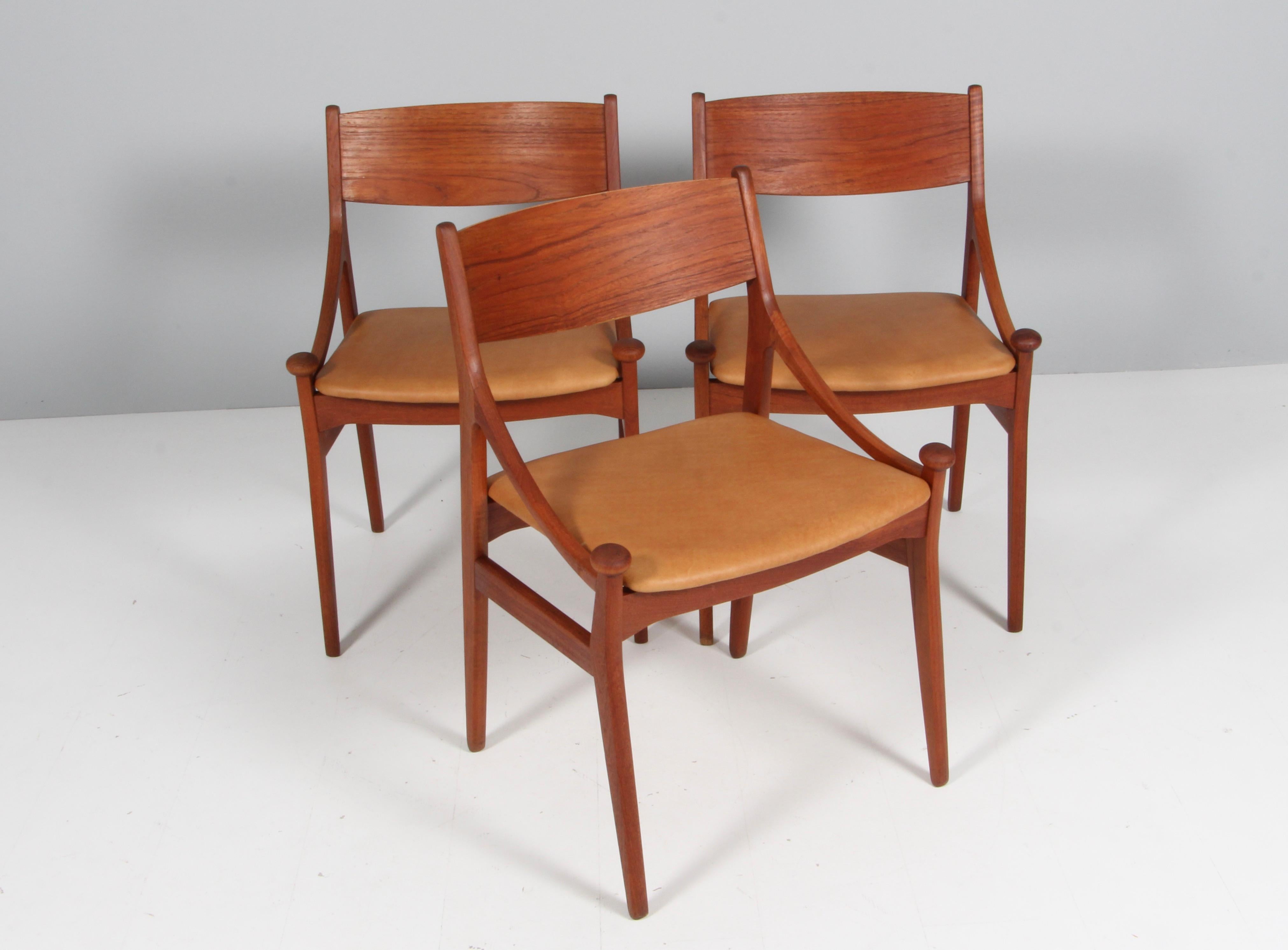 Vestervig Eriksen set of three dining chairs in partly solid teak. 

Seats new upholstered with tan vintage aniline leather.

Made by Brdr. Tromborg’s Eftf., Møbelfabrik Vestervig Eriksen Aarhus.