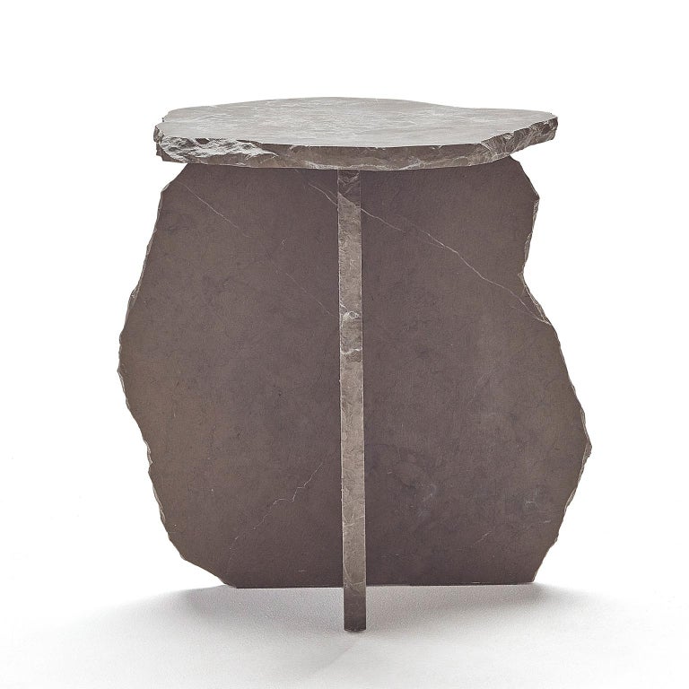 Vestiges side table is a pure brutalist table finished by hand and made entirely of exclusive marble from southern Spain. This four-legged side table, pretends to emphasise the look of an scheme of a pebble or an stone dolmen. Vestiges has a