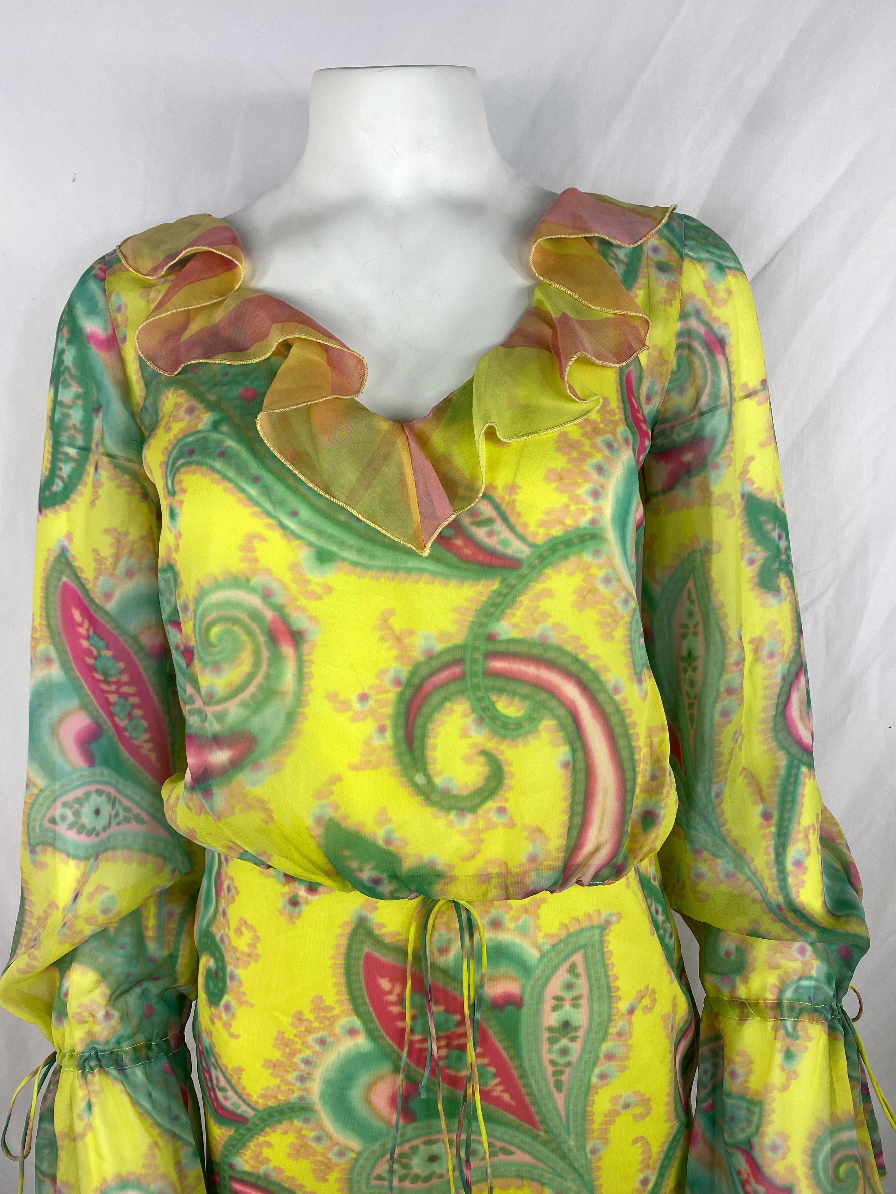 Product details:

The dress is made out of 100% silk, it features pink, green, yellow and orange colors with floral pattern, ruffle design and tie detail at the waist and the sleeves, mid length.