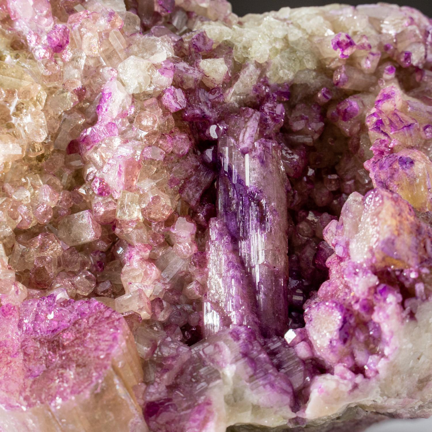 From Jeffrey Mine, Asbestos, Québec, Canada

Sparkling cluster of large cluster of violet-colored vesuvianite crystals crystallized all around on greenish massive vesuvianite matrix. It appears the earliest vesuvianite crystals are green color, with