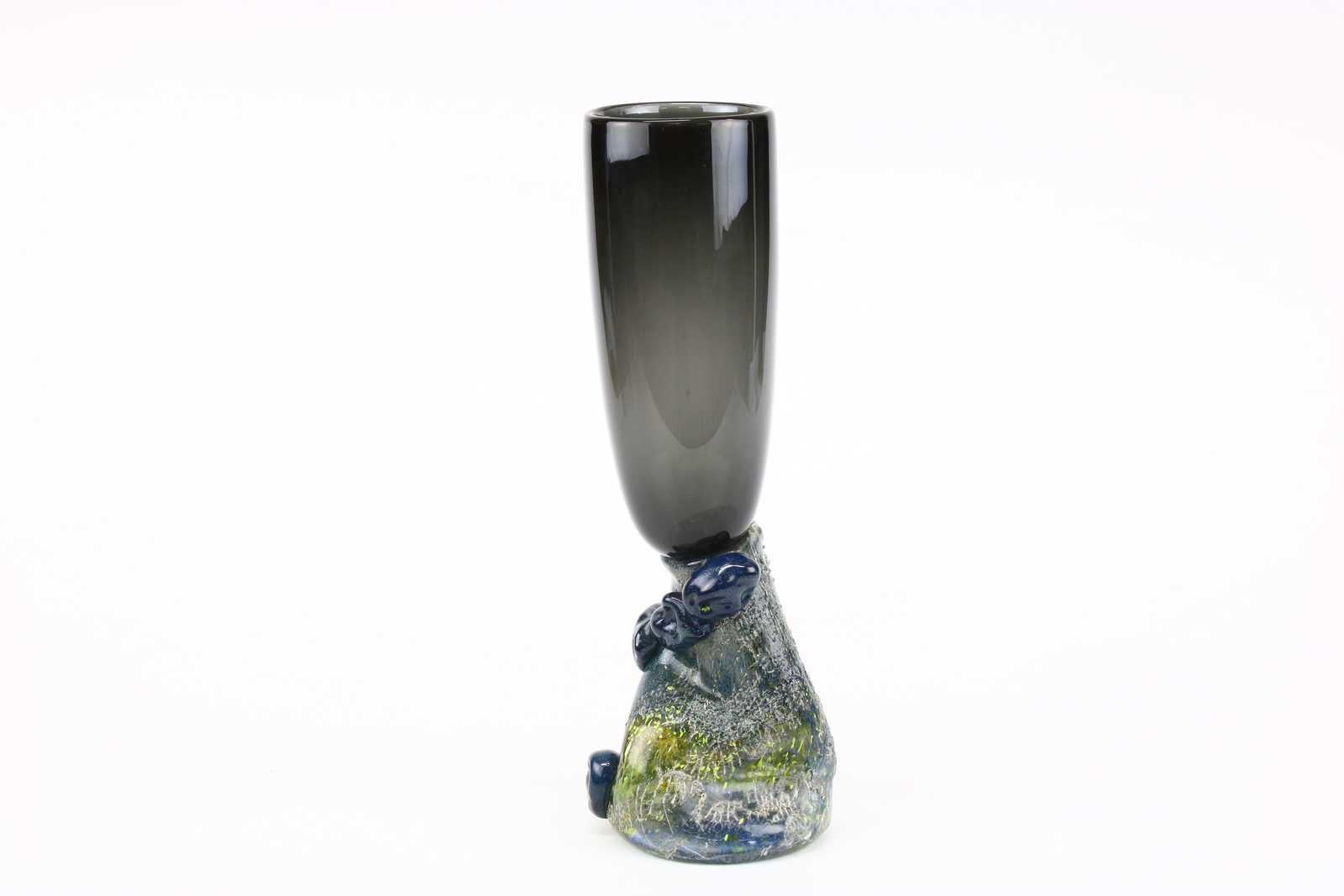 Vesuvius Transcontinental, a unique art glass vase by the Swedish glass artist Björn Stern, crafted in the year 1989. This captivating vase is more than just a glassware; it's a journey through time and imagination. 

The name 