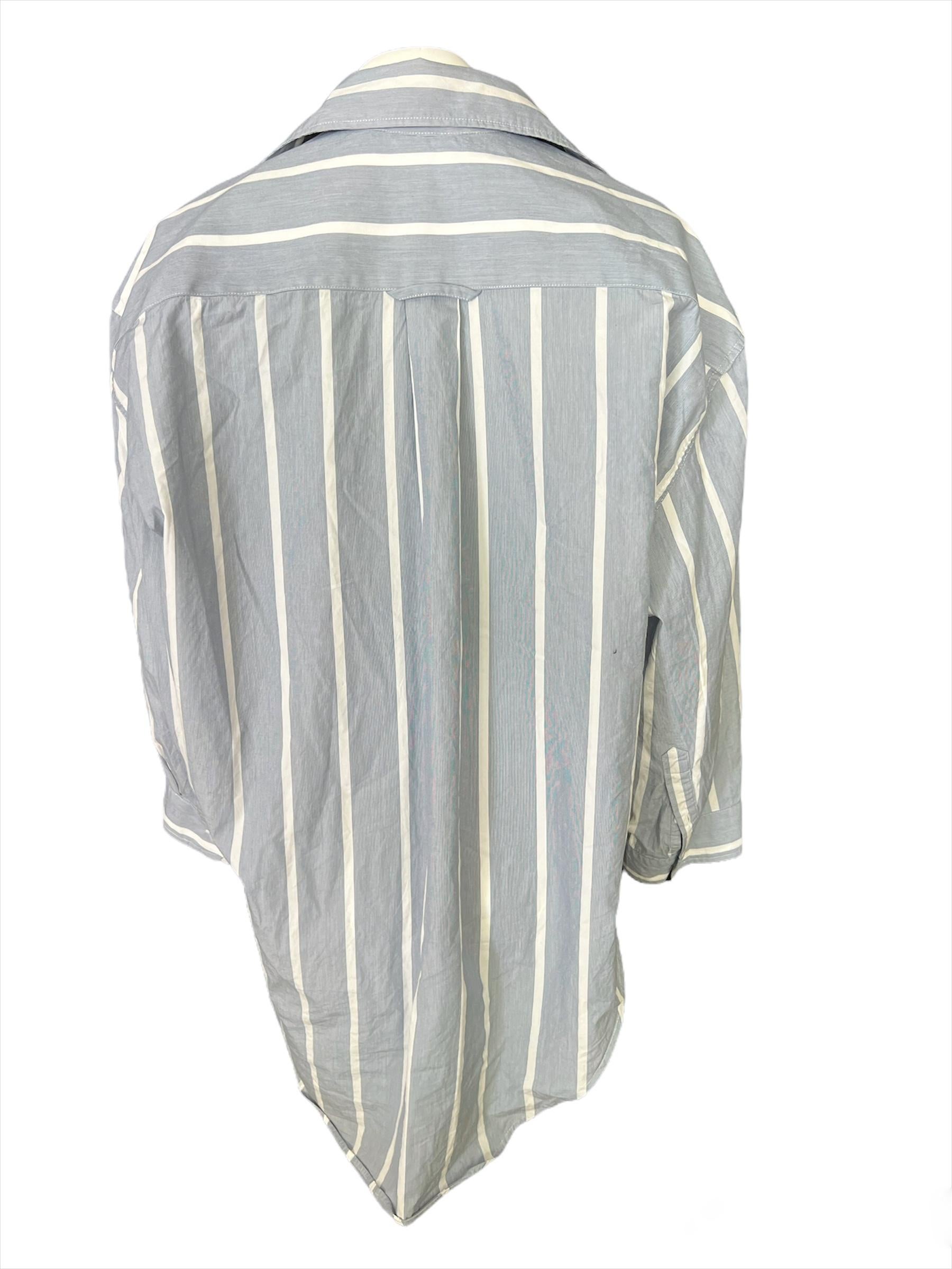 - Striped pattern
- Long sleeves 
- Asymmetrical style
- Oversized fit
- Side pocket detail 