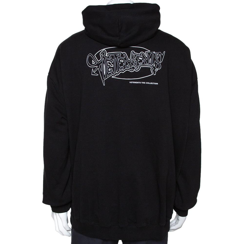 This black hoodie by Vetements is a perfect pick for a relaxed day. It is crafted from a cotton blend and keeps you comfortable. It features long sleeves and graphic prints. The color of the prints contrasts well with the dark background. It is an