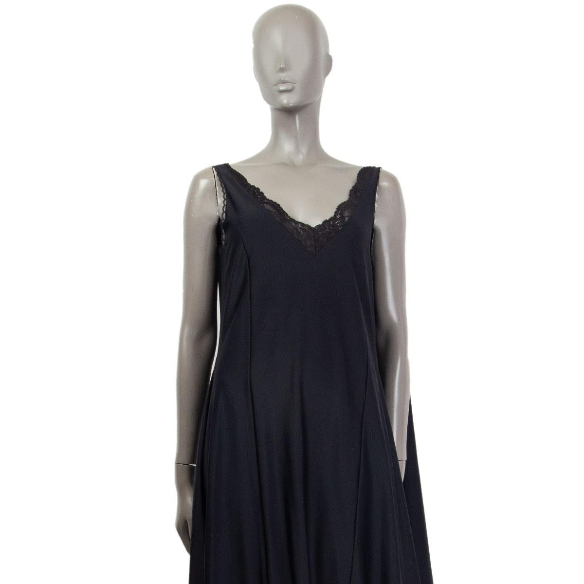 100% authentic Vetements lingerie wrap sleeveless mid-length dress in black stretch jersey, polyamide (82%) and elastane (18%). Tonal lace trim throughout. Integrated shawl-style panel to wrap around. Closes with a zipper on the left side. Unlined.