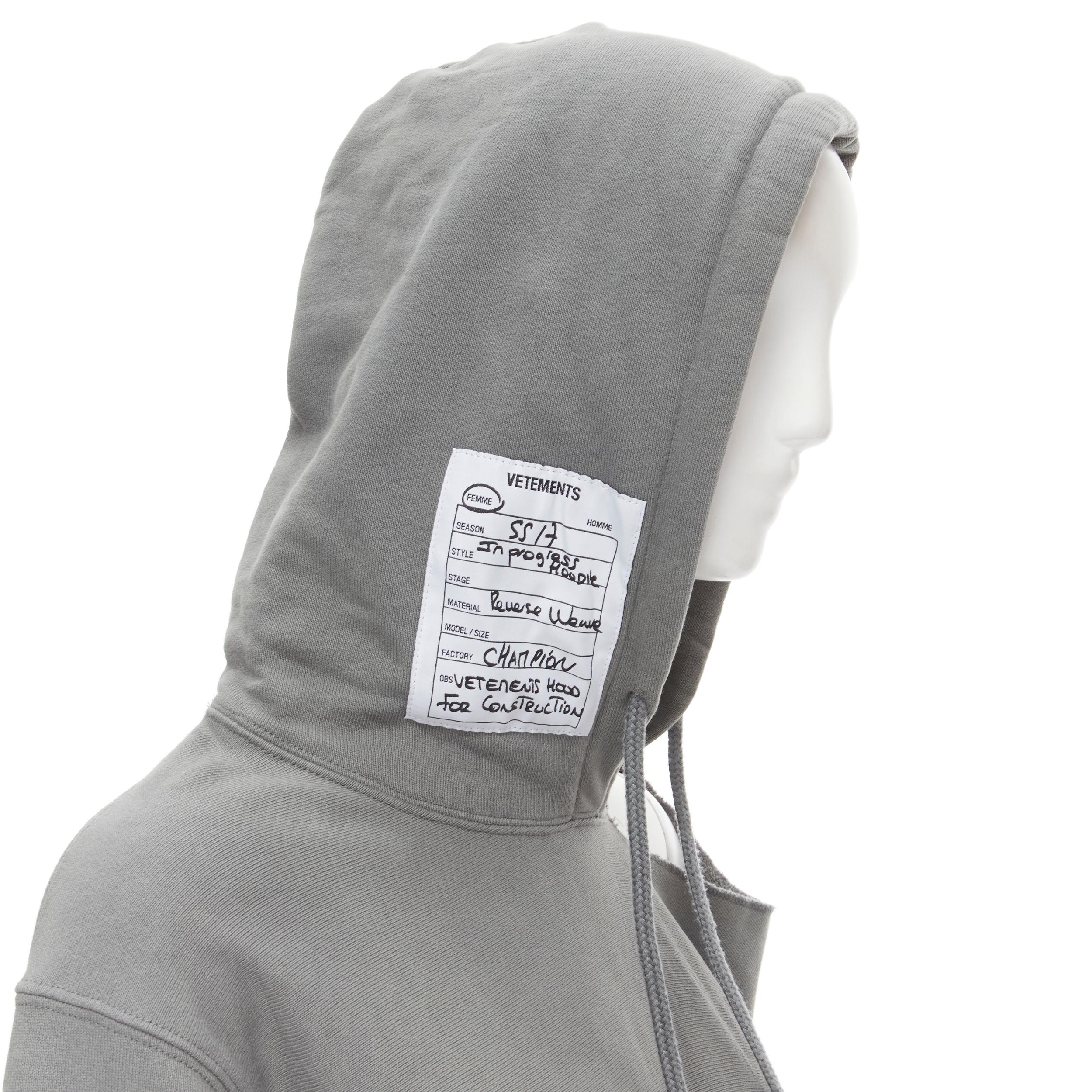 VETEMENTS Champion 2017 Demna Reverse Weave grey cotton hole shoulder hoodie S 
Reference: MELK/A00028 
Brand: Vetements 
Designer: Demna 
Collection: 2017 
Material: Cotton 
Color: Grey 
Pattern: Solid 
Extra Detail: Label patch design on hood.