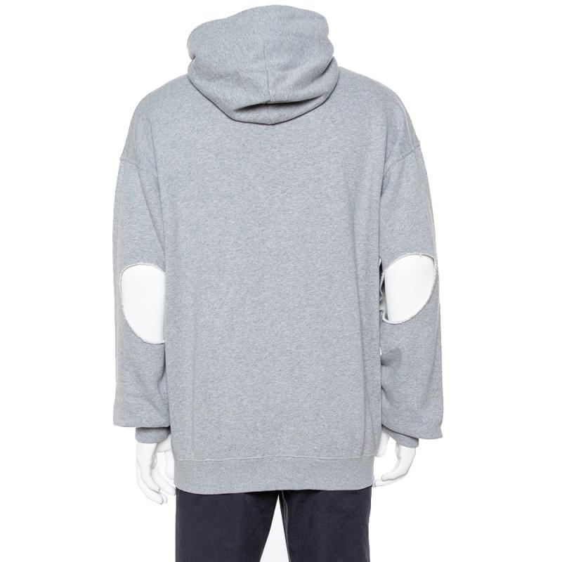 Embrace casual fashion in a cool way with this hoodie from Vetements. It is made from cotton in a relaxed shape and detailed with elbow cutouts on the long sleeves and zipped front. The grey creation is comfortable and stylish.

Includes:Price Tag