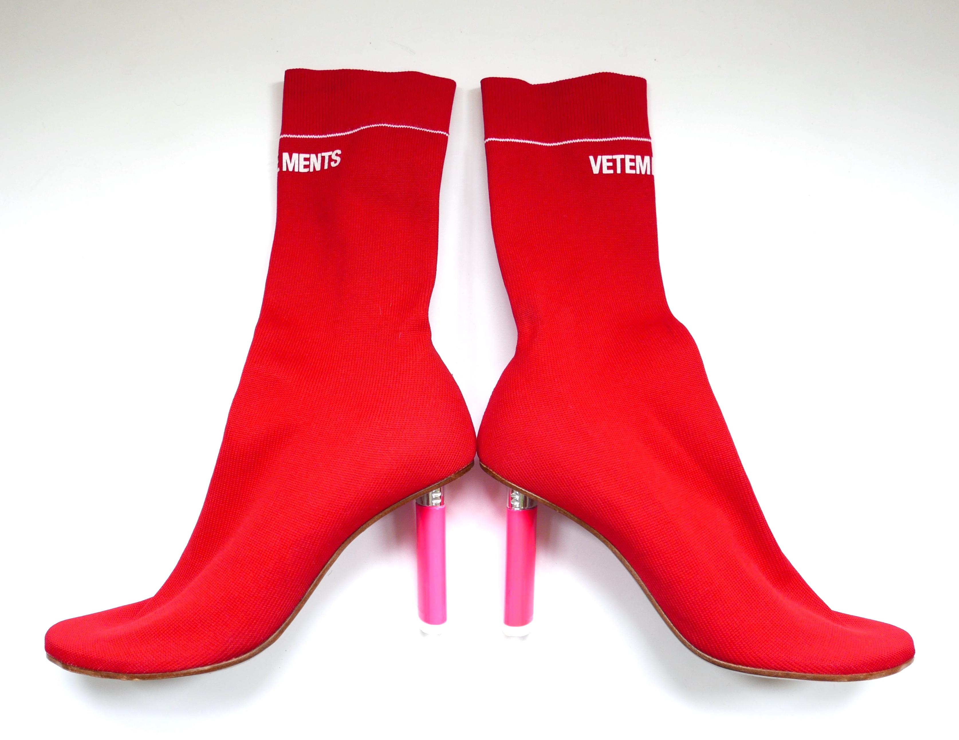 Iconic Vetements lighter heel sock boots in bright red and white ribbed knit with pink plastic disposable lighter shaped heels and logo tops. Worn once - have a few super light surface marks. Size 36. Measure approx 9.75” heel to toe and heels 3”
