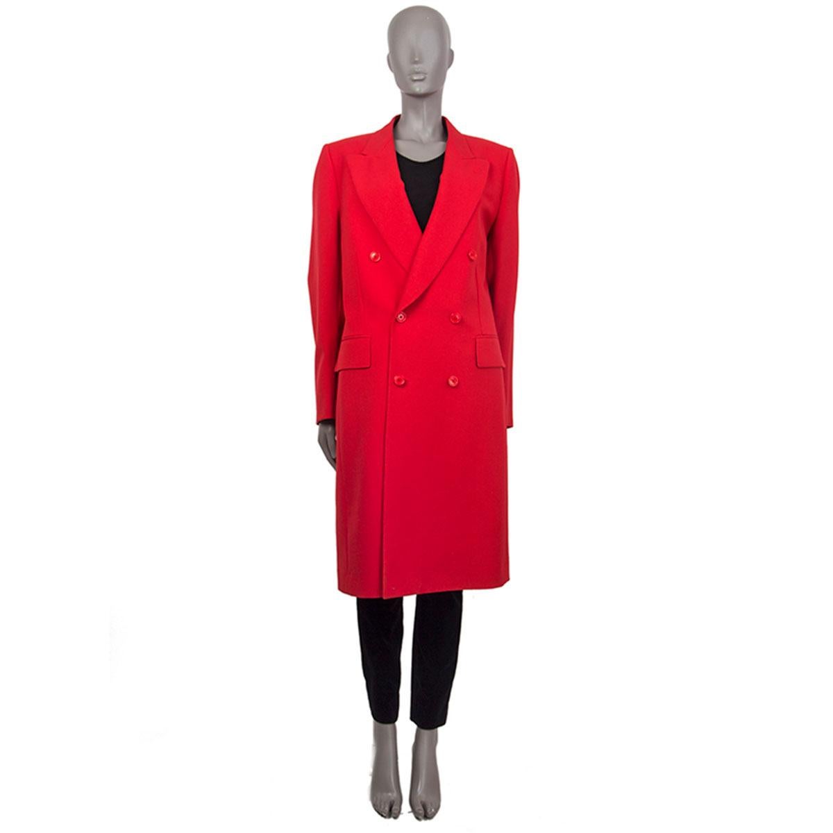 100% authentic Vetements double-breasted peak-collar coat in red virgin wool (100%). With two flap pockets on the sides, buttoned cuffs, slit on the back, and satin suspenders on the inside. Closes with red brand buttons on the front. Lined in red