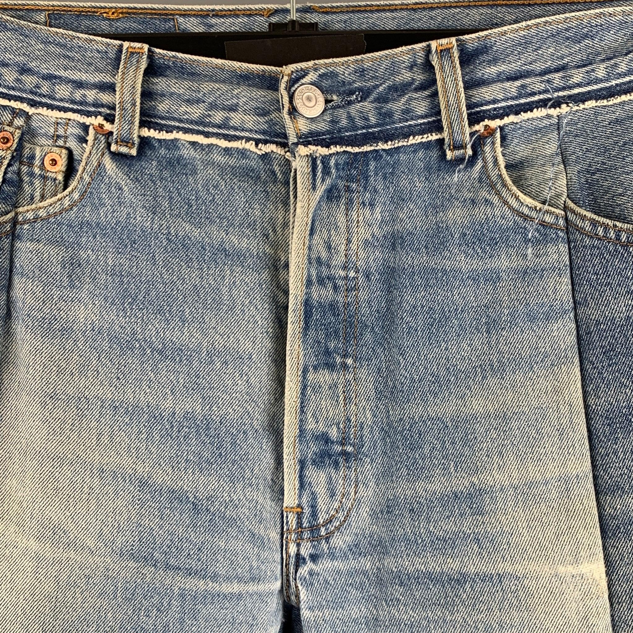 VETEMENTS x LEVI STRAUSS jeans comes in a blue denim featuring a regular fit, distressed detailing, and button fly closure.Excellent Pre-Owned Condition. 

Marked:   L 

Measurements: 
  Waist: 30 inches  Rise: 9.5 inches  Inseam: 28 inches 
 
  
 