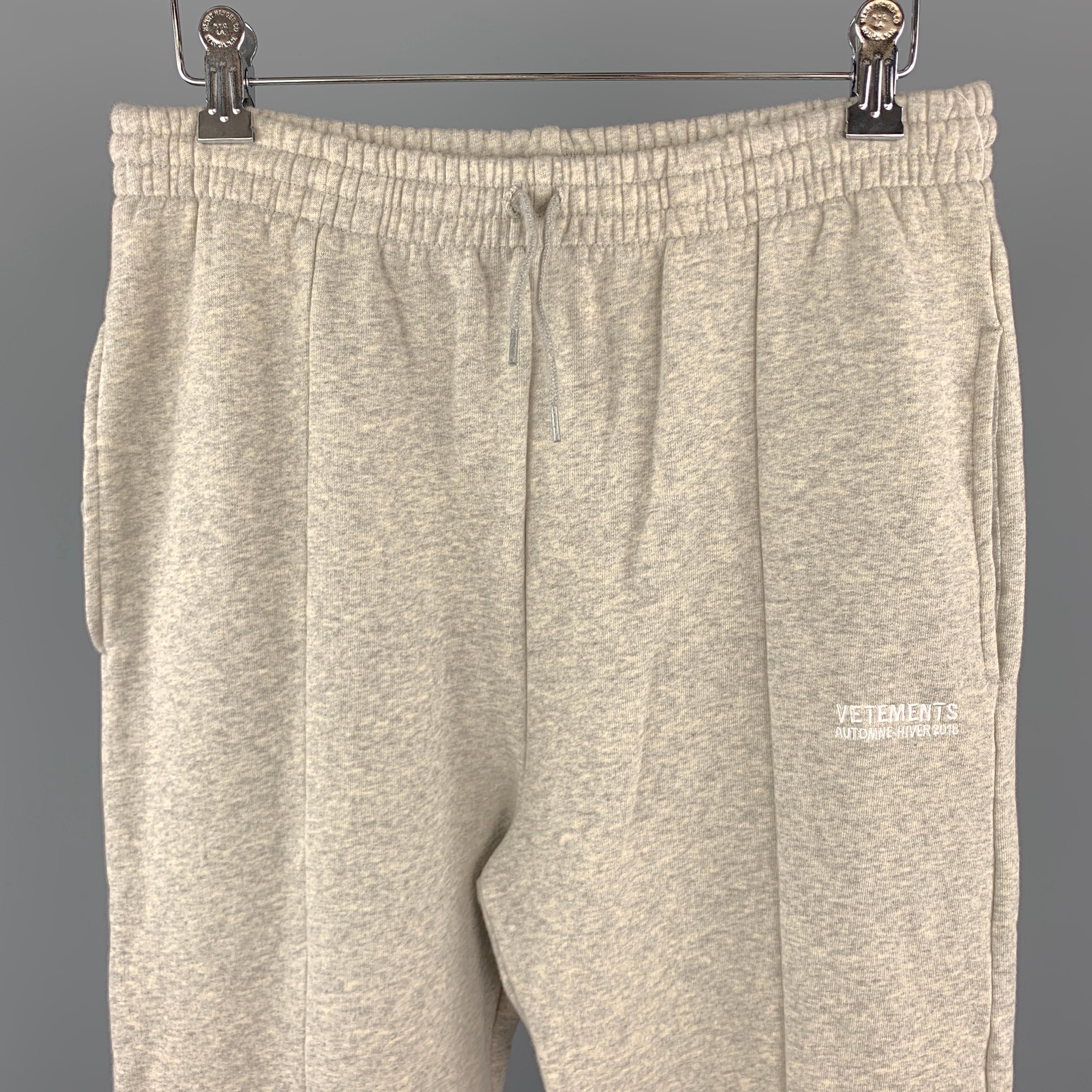 VETEMENTS Sweatpants comes in a light grey tone in a cotton / elastane material, with a drawstring, slit pockets, and detailed cuffs. Made in Portugal. 

New With tags.
Marked: L

Measurements:

Waist: 29 in. 
Rise: 13.5 in. 
Inseam: 30 in. 