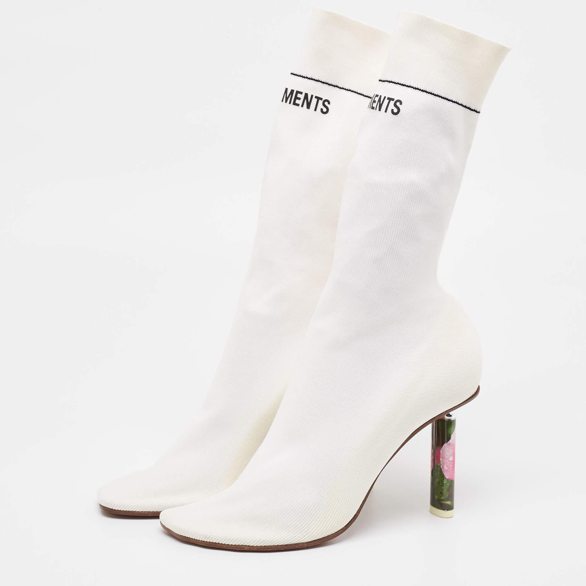 Crafted with meticulous attention to detail the Vetements boots exude contemporary charm. These snug yet stylish boots embrace your feet with a soft knit fabric seamlessly blending comfort and fashion. Their sleek silhouette and versatile white hue