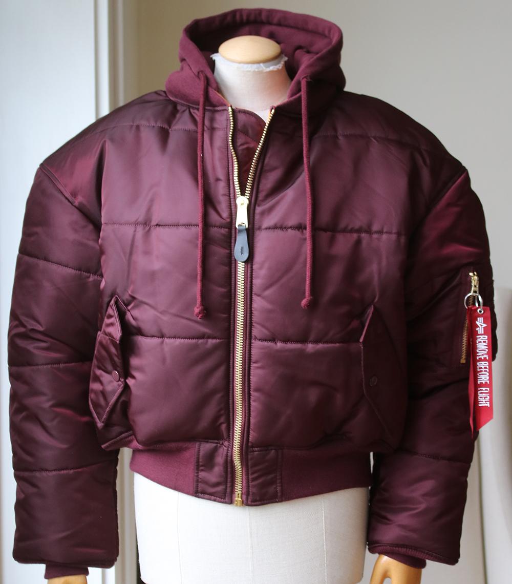 Double-sided oversized bomber jacket from the Vetements x Alpha Industries collection made of a high-shine polyamide fabric. Burgundy and quilted on one side, orange and back-patched on the other, this style features red ribbons on the sleeve