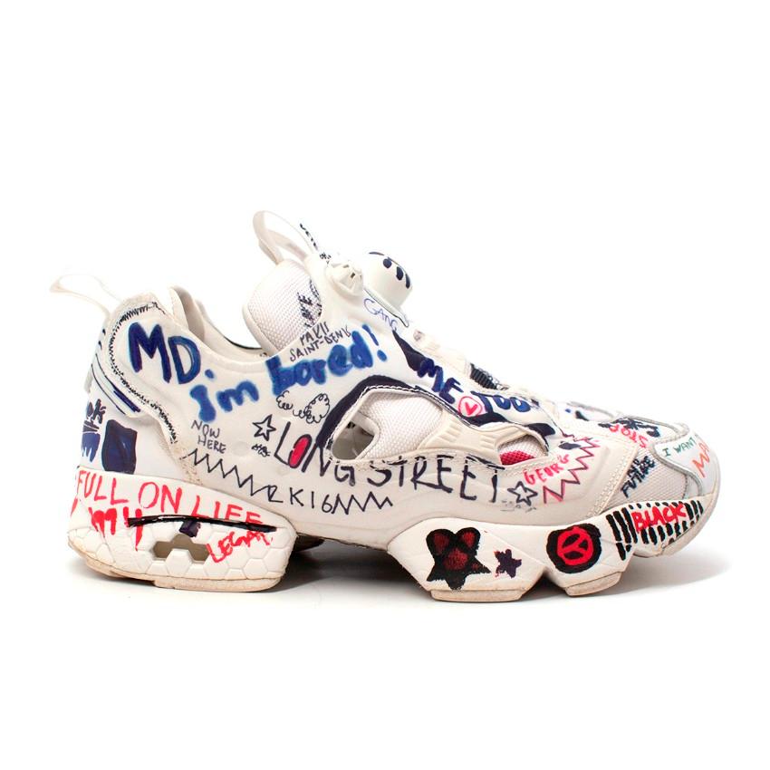 Vetements x Reebok White Graffiti Instapump Sneakers
 

 - White sneakers covered with multicolour graffiti-style dooles across the upper and midsole
 - Logo pull tab at tongue with Instapump system
 - Chunky sole
 

 Materials:
 Synthetic 
