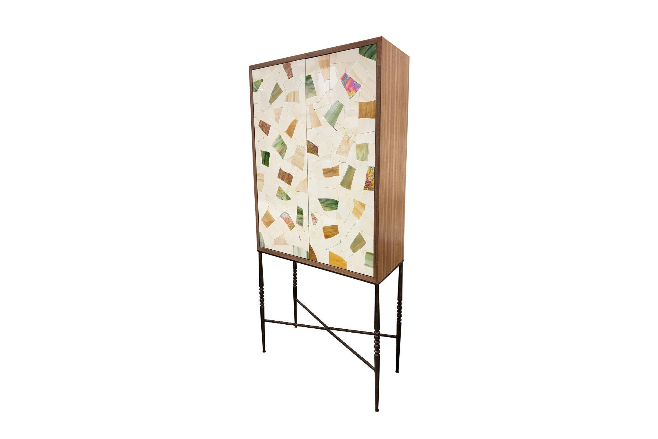The Milano bar cabinet by Ercole Home has a 2-door front, with a natural walnut finish on oak. Handcut glass mosaics in light ivory vetrazzo mix glass mosaic decorate the surface in a continuous Vetrazzo pattern.
Custom sizes and finishes are