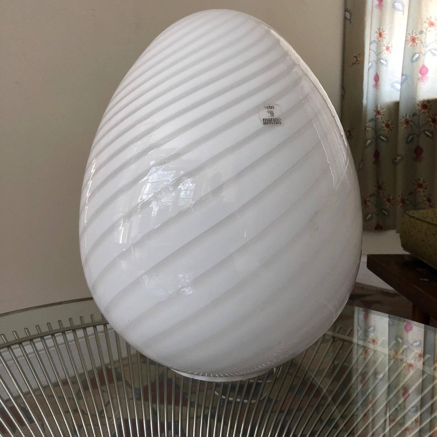 A fun egg lamp, signed Vetri Murano, circa 1980s. Cased glass with a Classic swirl pattern. This is a big egg at 17