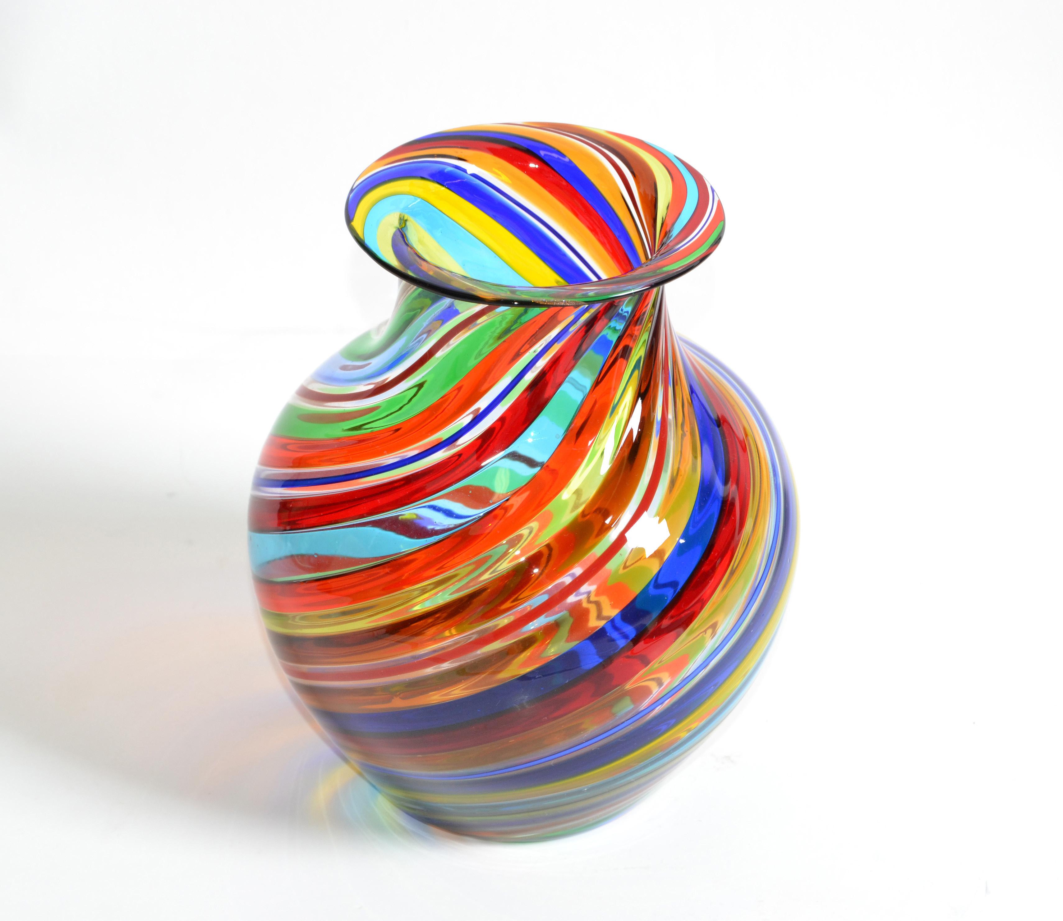 Mid-Century Modern Italian blown Murano vase in swirl design motif of red, white, blue, yellow and clear coloring.
Marked with foil label, Vetro Artistico Murano.